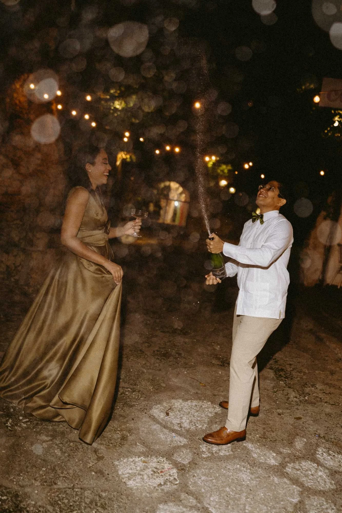 Night wedding photography with direct flash, champagne pop celebration in Dominican Republic.