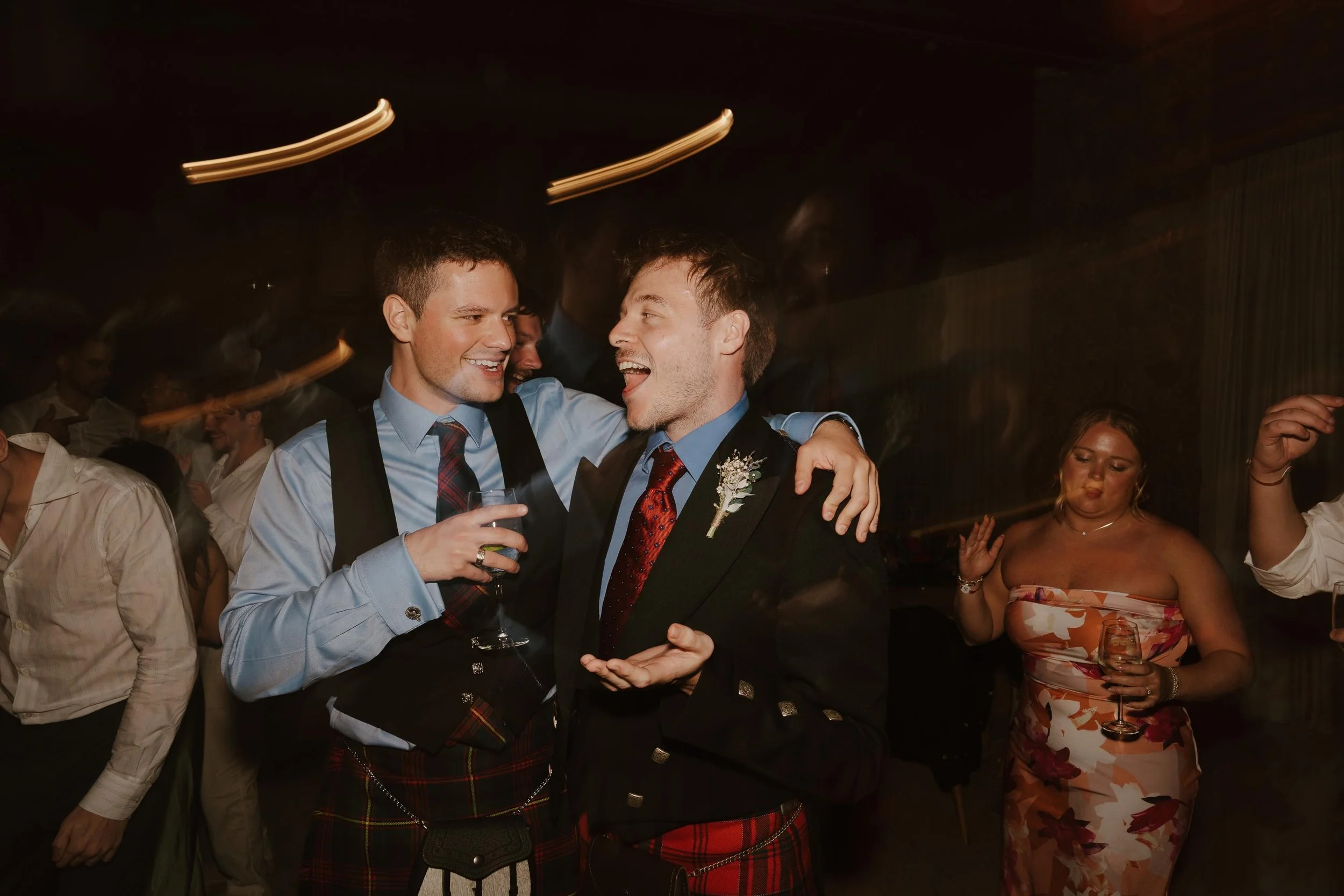 Candid and energetic wedding reception party in Punta Cana, with guests dancing and celebrating under warm lights