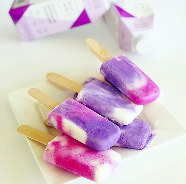 Pretty pink &amp; purple pops💜💗 To make: combine vanilla yogurt with a splash of @picnikshop creamer. Separate into 3 bowls. Stir in half a thawed pitaya packet in one of the bowls. In another, stir in thawed pitaya with a pinch of blue majik powde