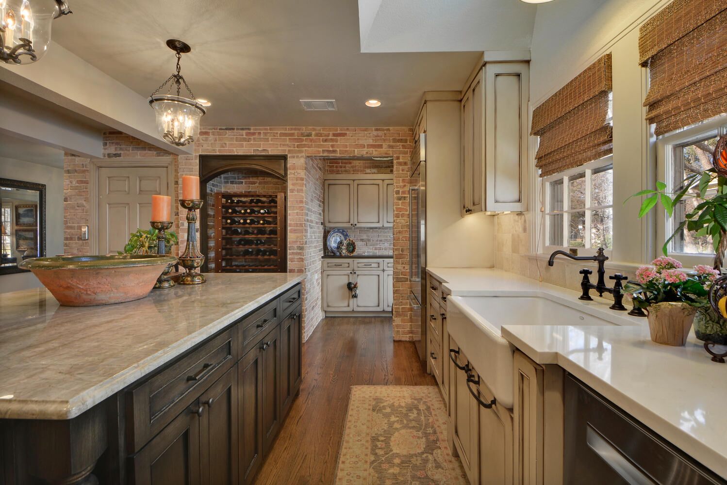 Multi-color kitchen cabinets with cabinet pull handles in center island