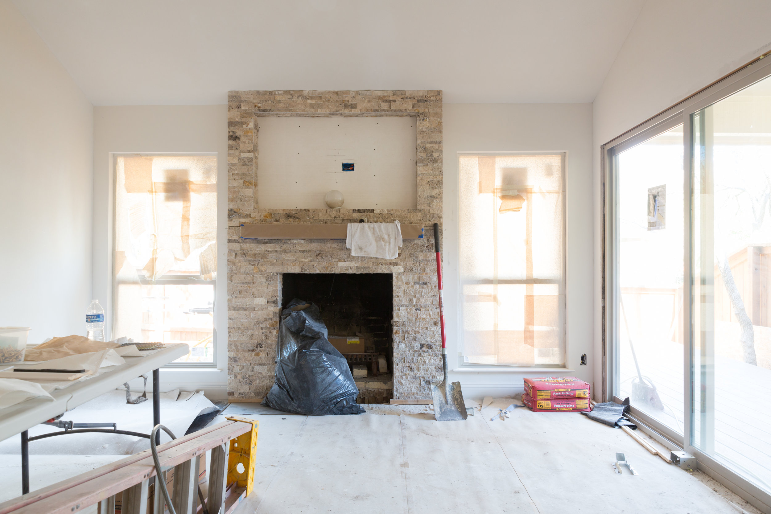 Complete townhome remodel living room with stacked stone firelpace