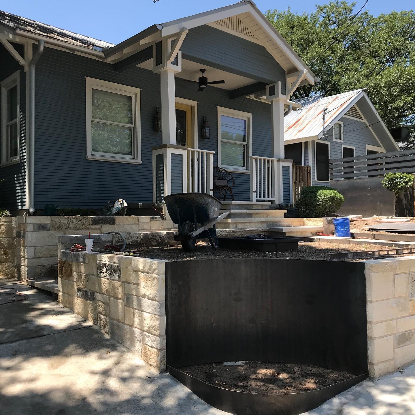 🚧WORK IN PROGRESS🚜⚡️⚡️it&rsquo;s amazing!✨✨
Swipe through ⬅️⬅️to see the before. 
.
.
.
.
.
Updated paint with a pop of sunshine on the front door paired with this exciting new landscape plan transform this Clarksville Cottage.  New stonework evoke