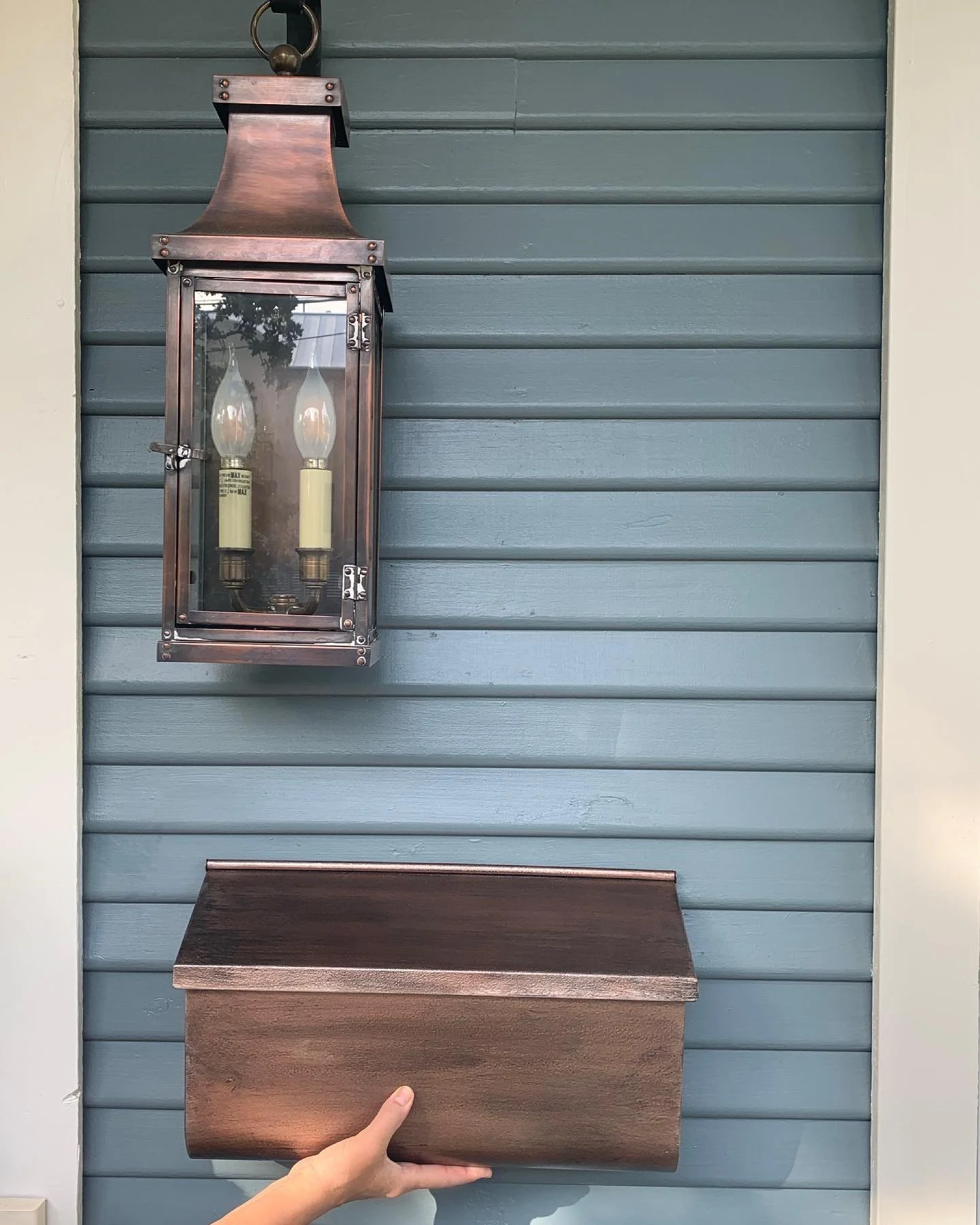 It&rsquo;s amazing what a little spray paint can do!! Swipe to see the before. This Clarksville cottage got new paint and beautiful copper lanterns. A couple coats of @rustoleum metallic exterior spray paint on the existing mailbox make for an almost