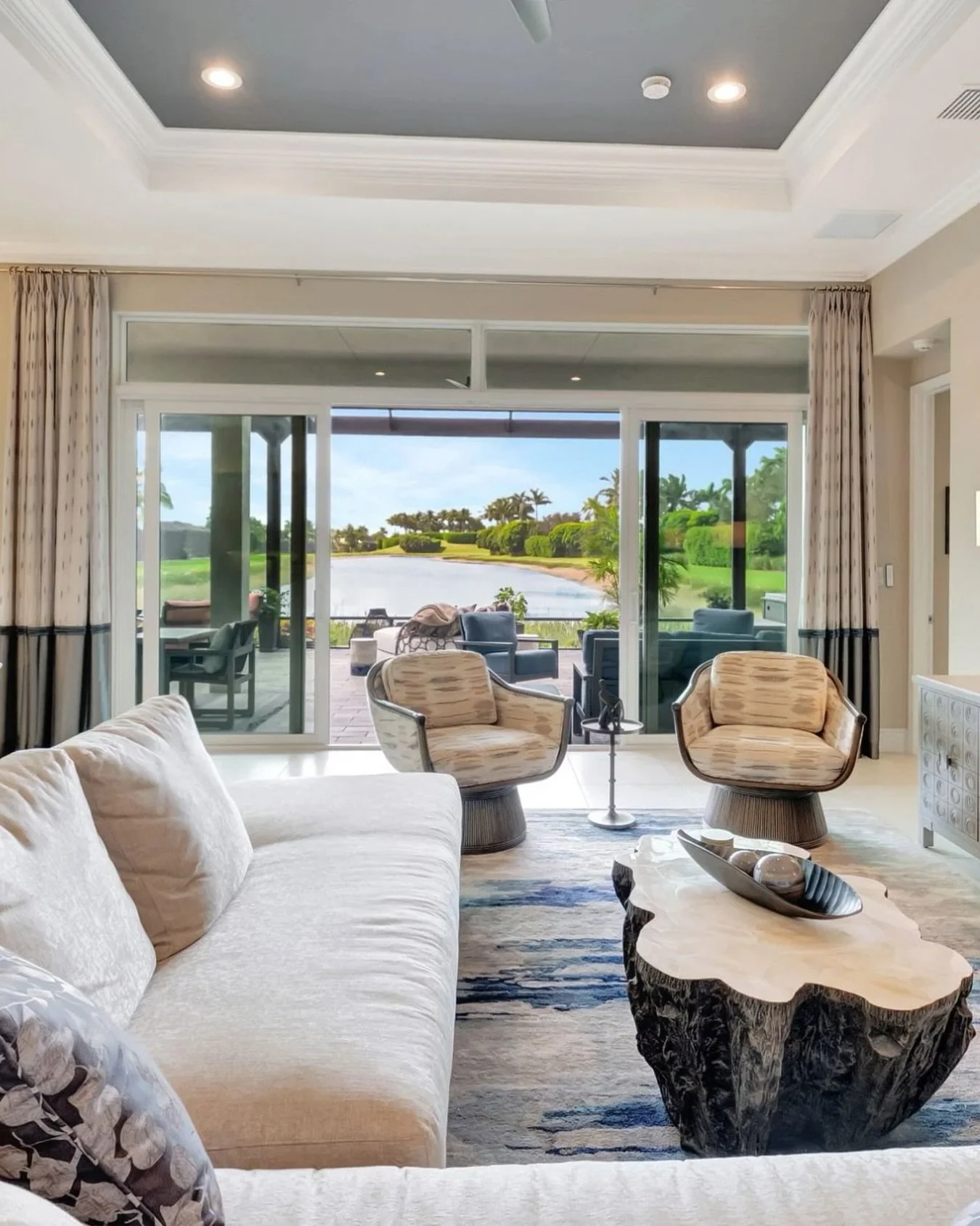 This living space is all about balance-soft, neutral tones layered with sculptural forms, organic textures, and thoughtful contrasts. The clean-lined sofa and cozy lounge chairs invite conversation, while the statement wood coffee table grounds the r