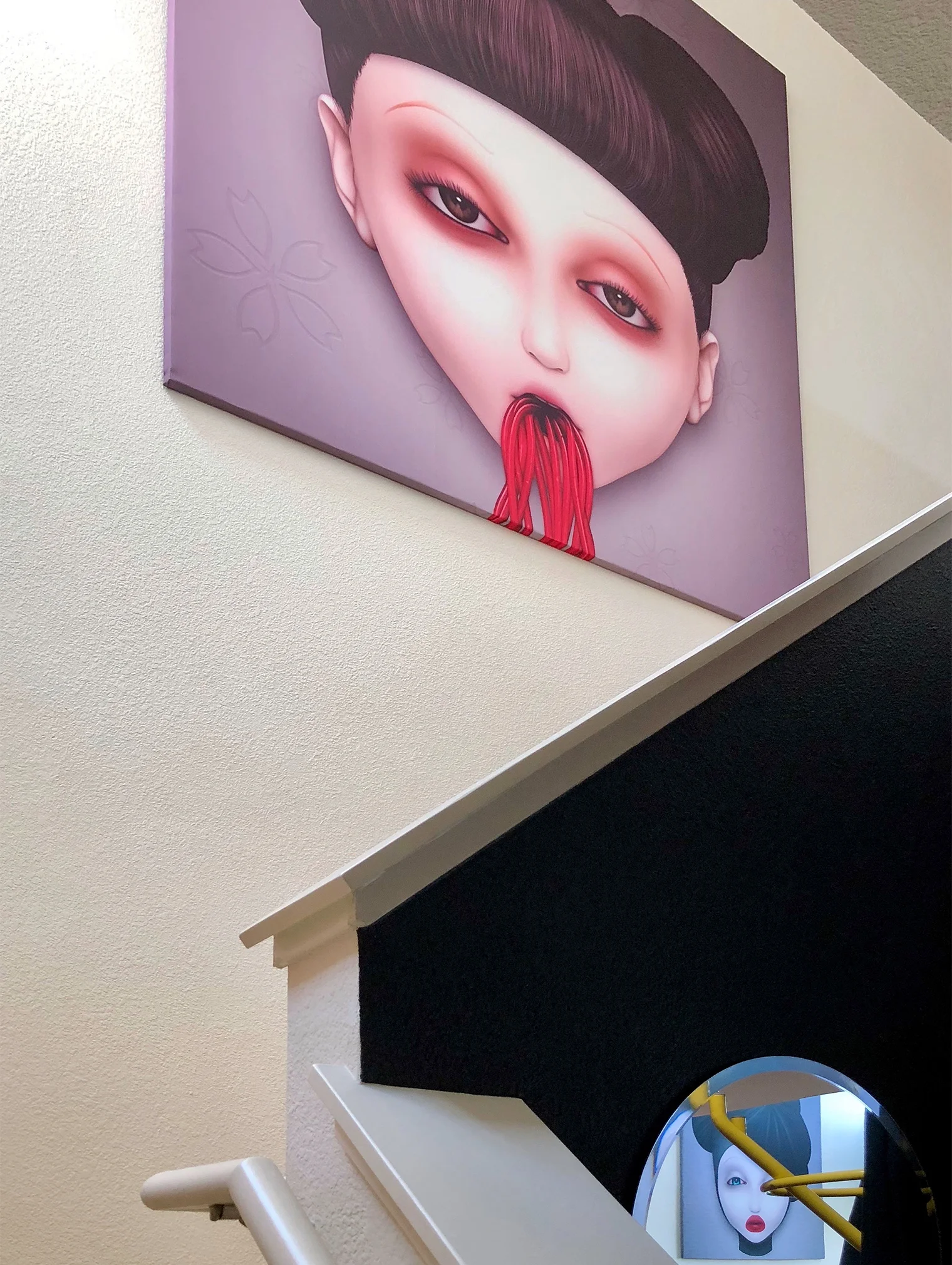 A large 6x6 foot print of Misfit Sakura hung on the stairway to the top floor, in the mirror you can glimpse the reflection of Misfit McQueen in the living room