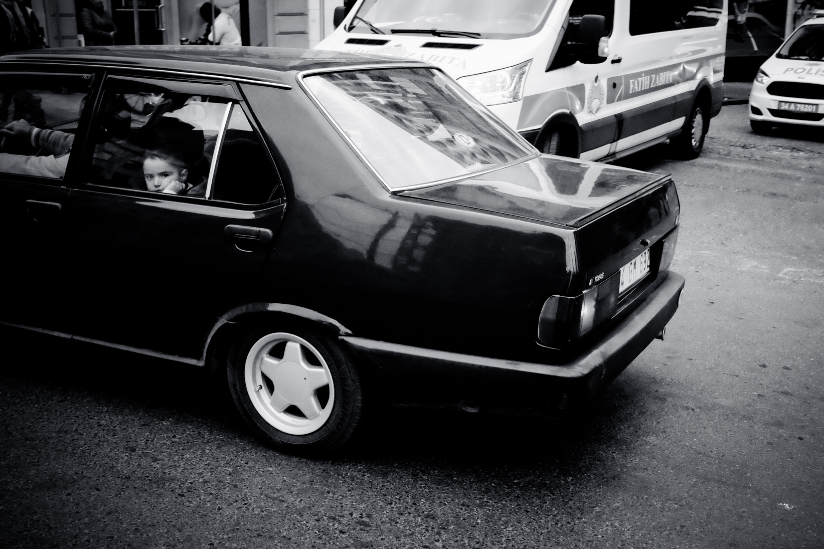 Street Photography. This show was taken in Istanbul just as a car was passing. I noticed the child in the back seat looking at me and so, quickly I snapped this. The angles off slightly but I really quite like it. It’s in black and white and was taken on a Fuji Z100s.