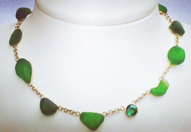 Imagine! 
Trash is treasured, REImagined! 

An 18 karat gold collier set with a collection of bottle green sea glass &lsquo;pearls&rsquo; and a single facetted bottle green tourmaline. 

Green like the 10 &lsquo;R&rsquo;s&rsquo; of circularity plus o