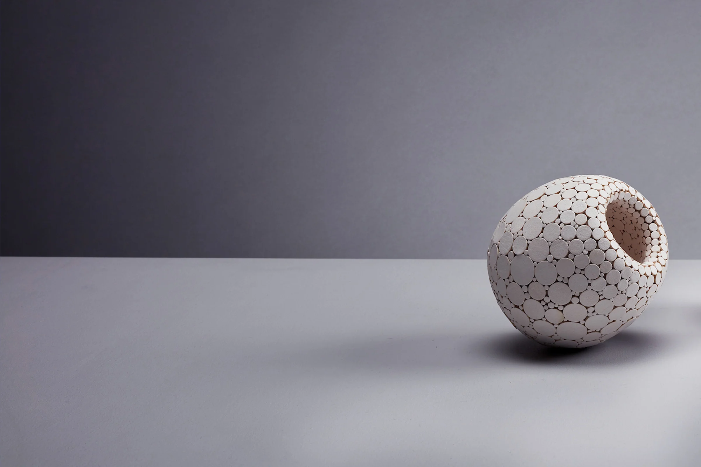 SPECIMEN No. 02 Date of Creation : 12/2017 Material : Clay fused with leather. Size : Width: 9.5cm, Depth: 9.5cm, Height: 9.6cm Weight: 0.318 kg Process : Hand sculpted clay vessel, decorated with leather disks. SOLD Private Collector, London 2019