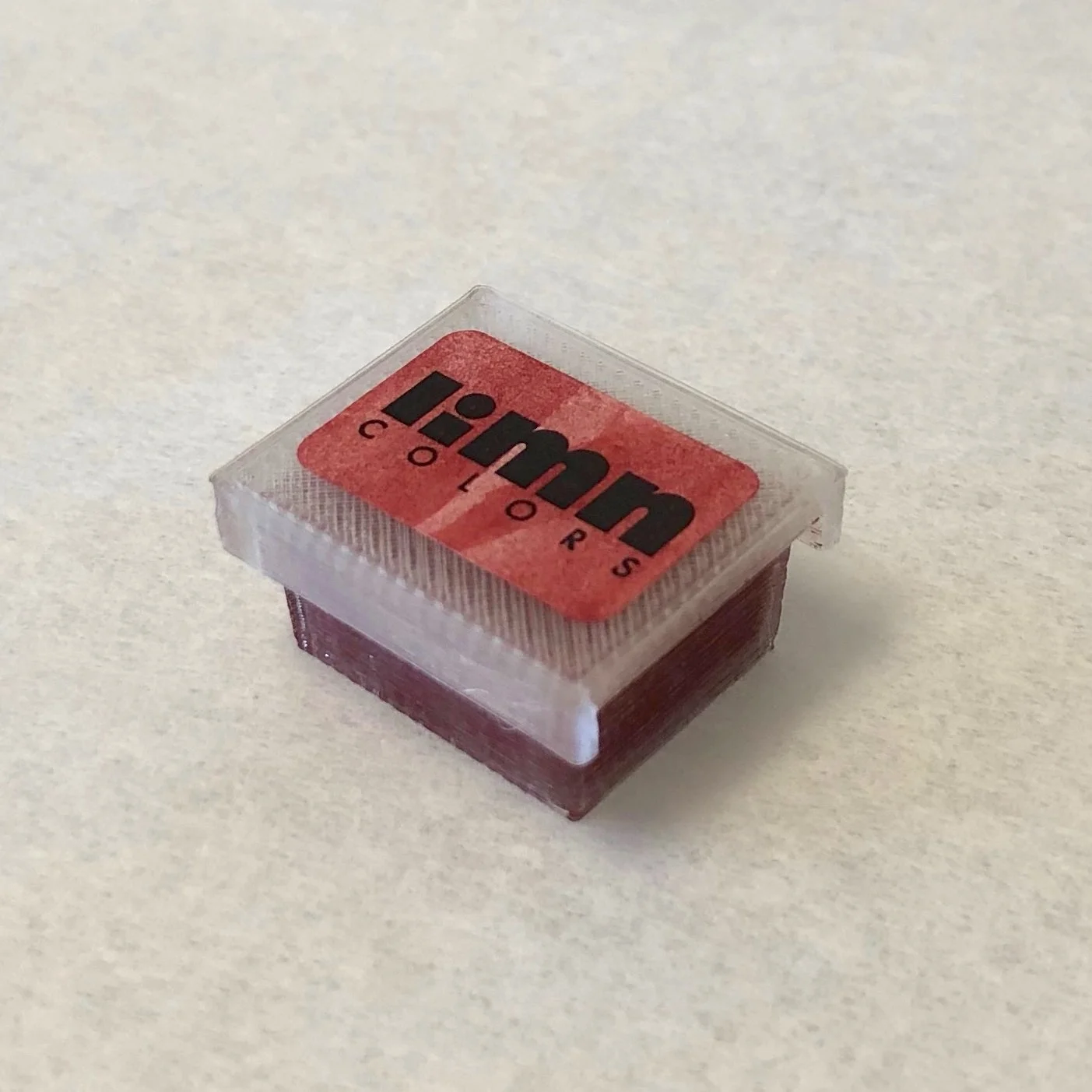 cadmium maroon lidded half pan.jpeg