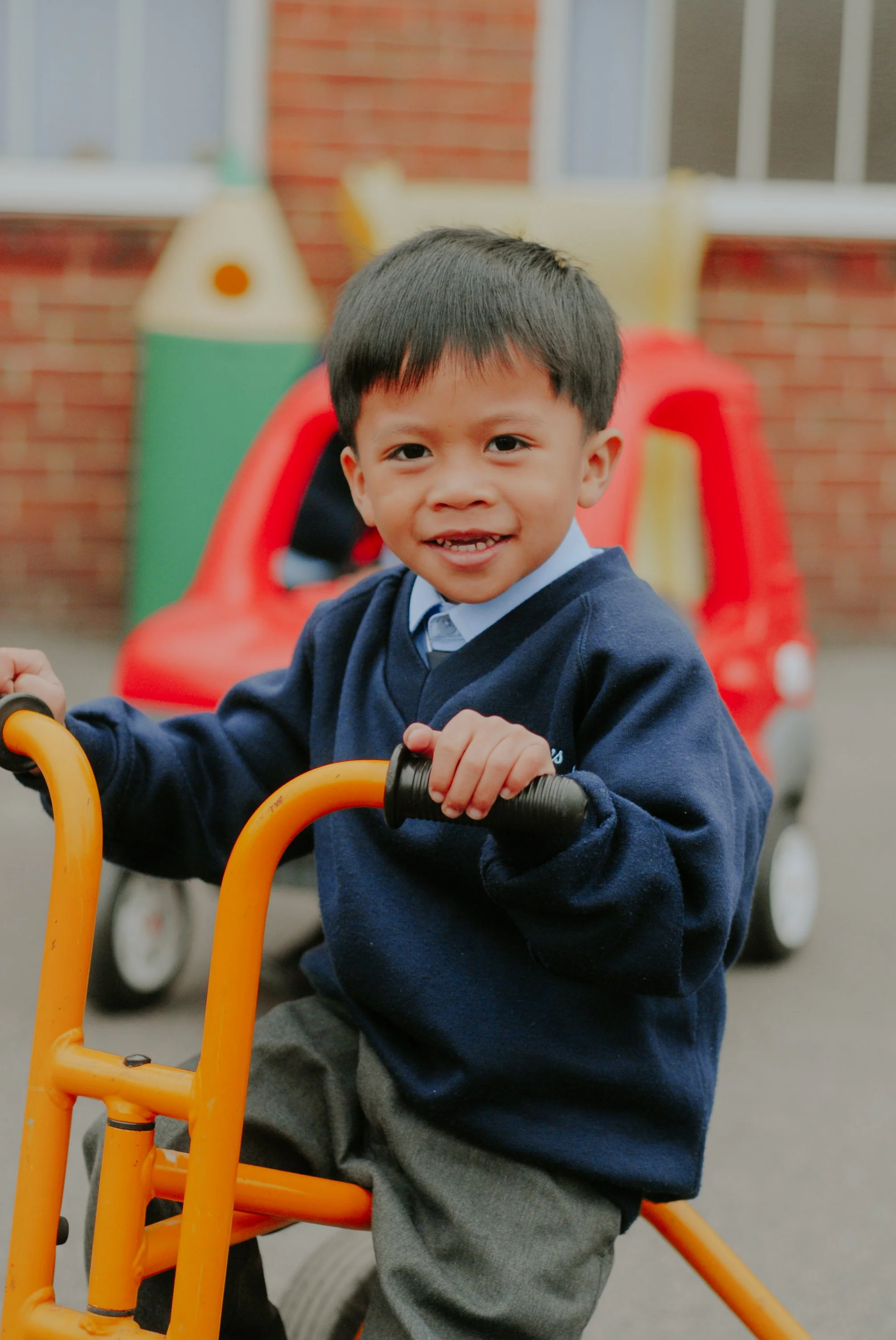  Pupil rides a yellow tricycle 