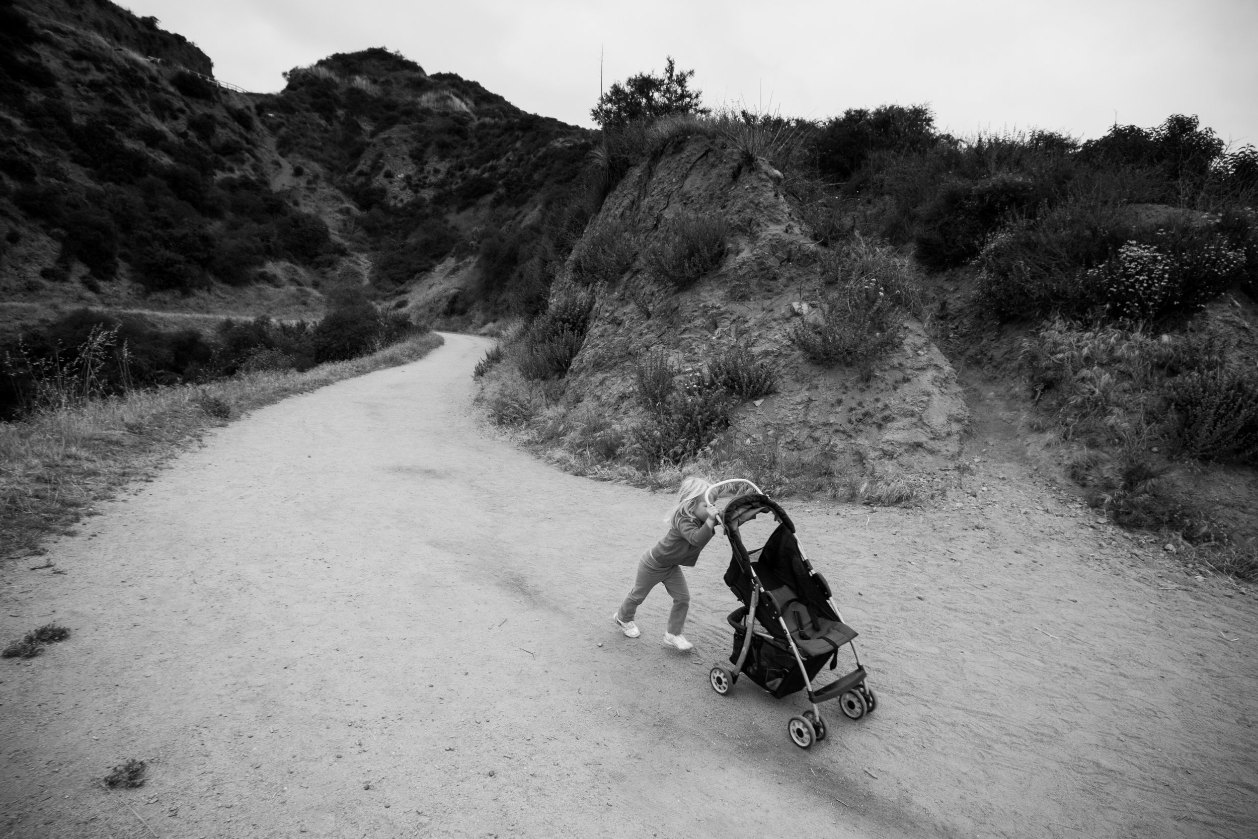  A girl pushes an empty stroller along a hiking trail May 14, 2011, on Mount Lee in Los Angeles. 