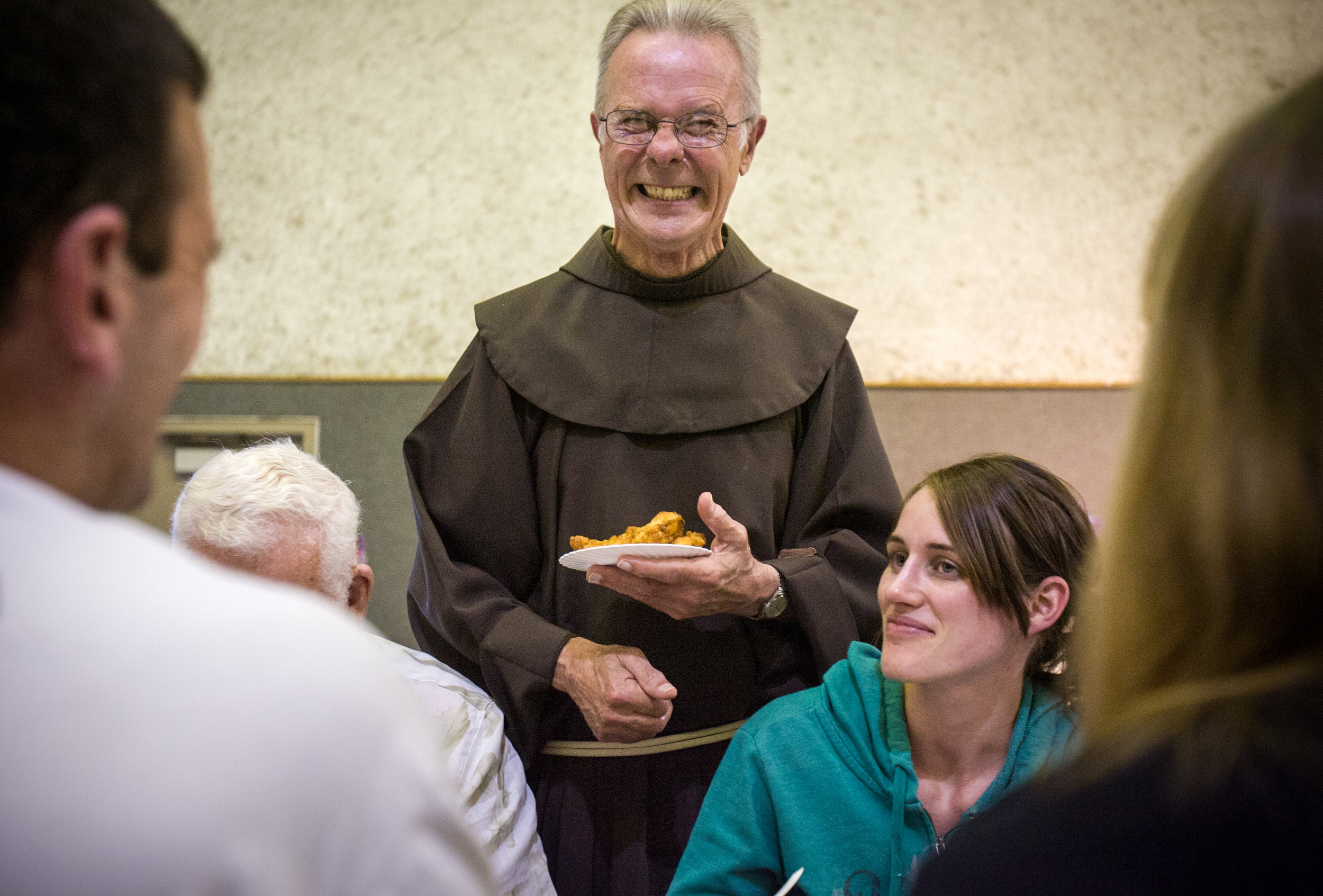  The Rev. Richard Juzix laughs as he makes his rounds through the dining hall during a fish fry supper April 1, 2011, at Sts. Simon & Jude Catholic Church in Huntington Beach, Calif. 