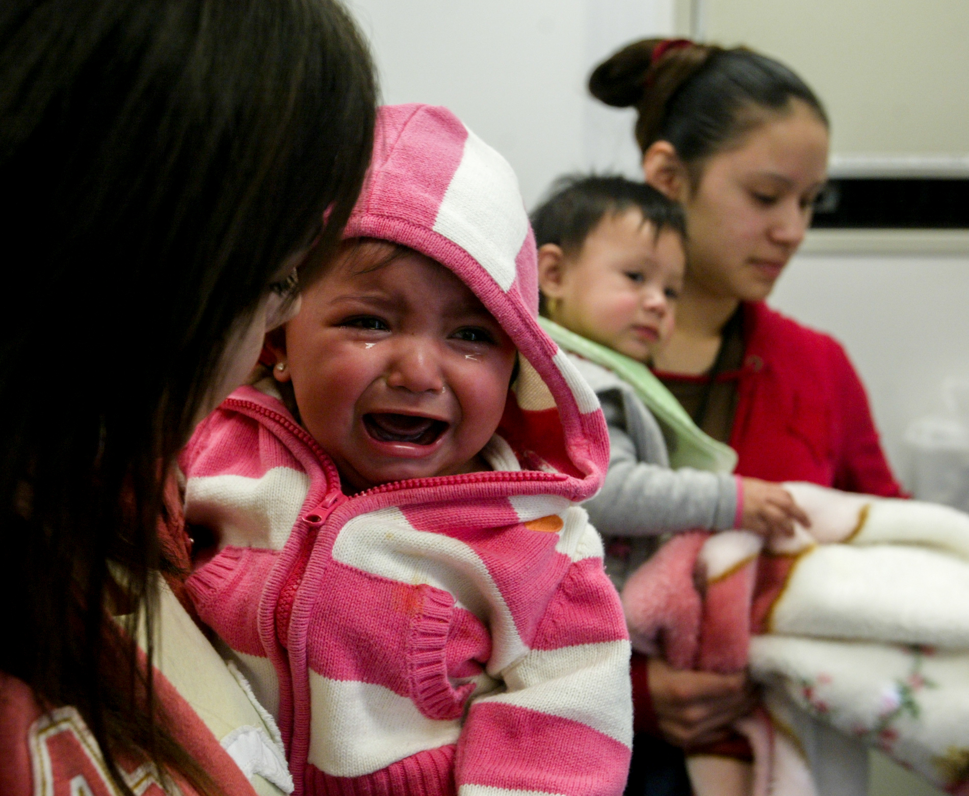 Irene Vera, left, 16, comforts her daughter, Aryana Vera, 10 months, after she received a checkup and a shot Thursday, Feb. 21, 2008, at the Ronald McDonald CareMobile in Odessa, Texas. At right is Xazmyn Martinez, 16, with her 10-month-old daughter