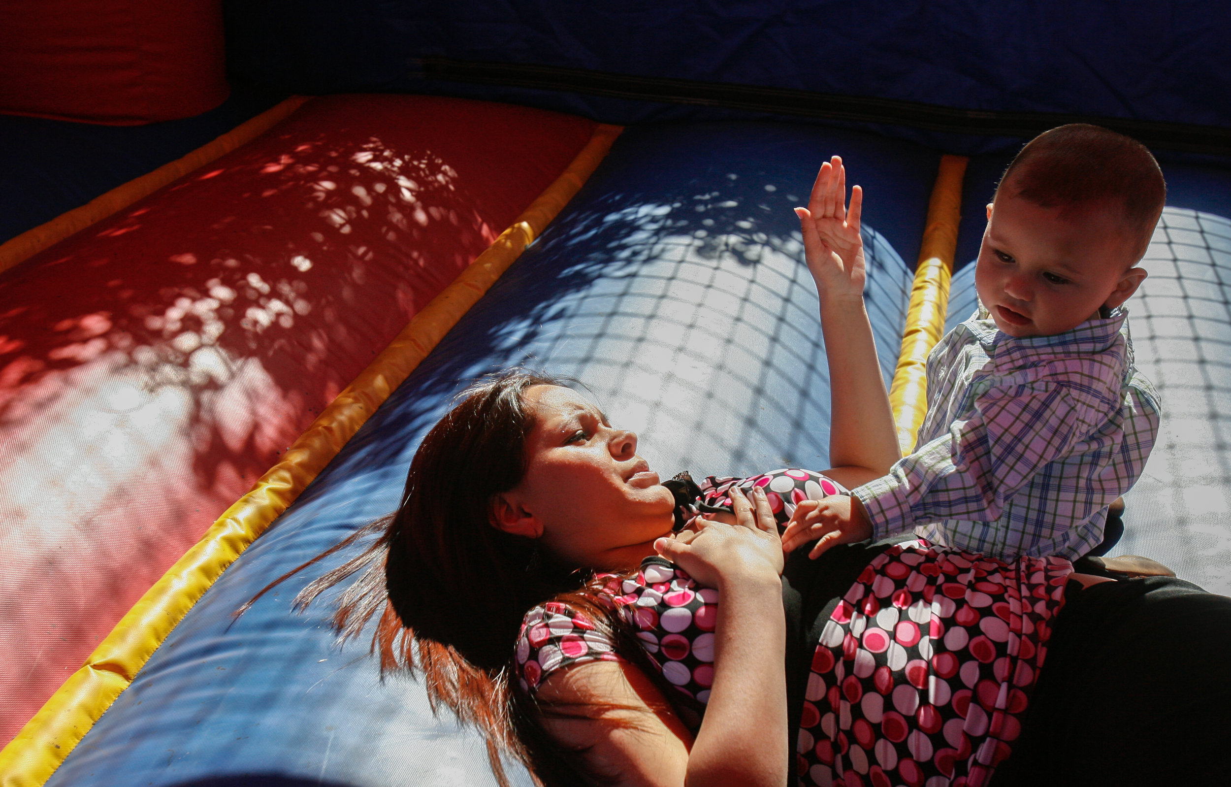  Susana Dominguez, 17, plays in a bounce house with her one-year-old son, Gabriel Acosta IV, during his birthday party April 12, 2008, in Odessa, Texas. 