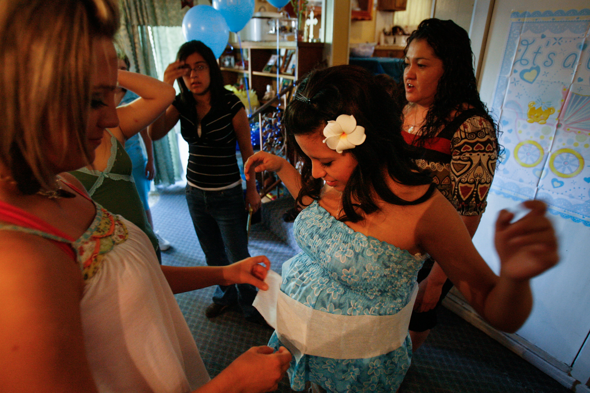  Friends and family play games with Dean Martinez, 17, center, during her baby shower April 19, 2008, in Odessa, Texas. 