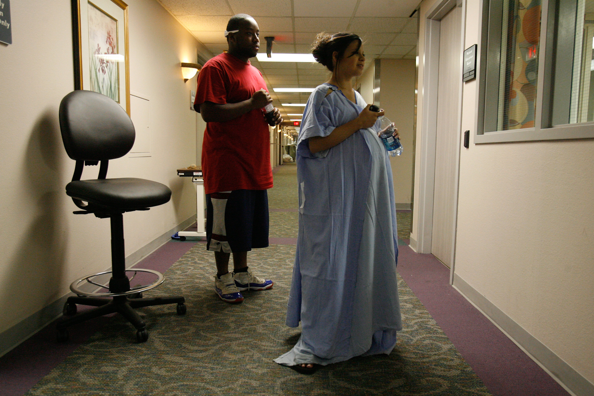  Deana Martinez, 17, right, and her boyfriend, Jyrick Sutton, look into the nursery window while walking the halls to speed up her labor late at night, May 20, 2008, at Medical Center Hospital in Odessa, Texas. 