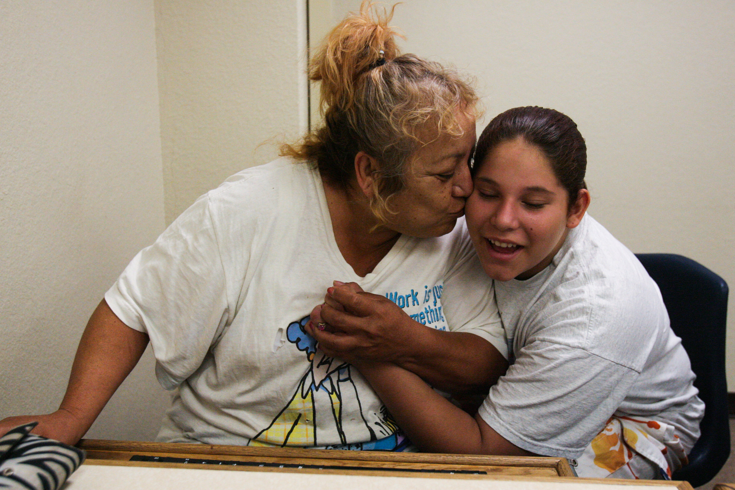  Homeless mother Juanita Torres, left, celebrates with her daughter Angelica Brito, 12, after learning that her request for financial aid is approved so that she can go back to college July 16, 2008, at the Ector County Public Library in Odessa, Texa