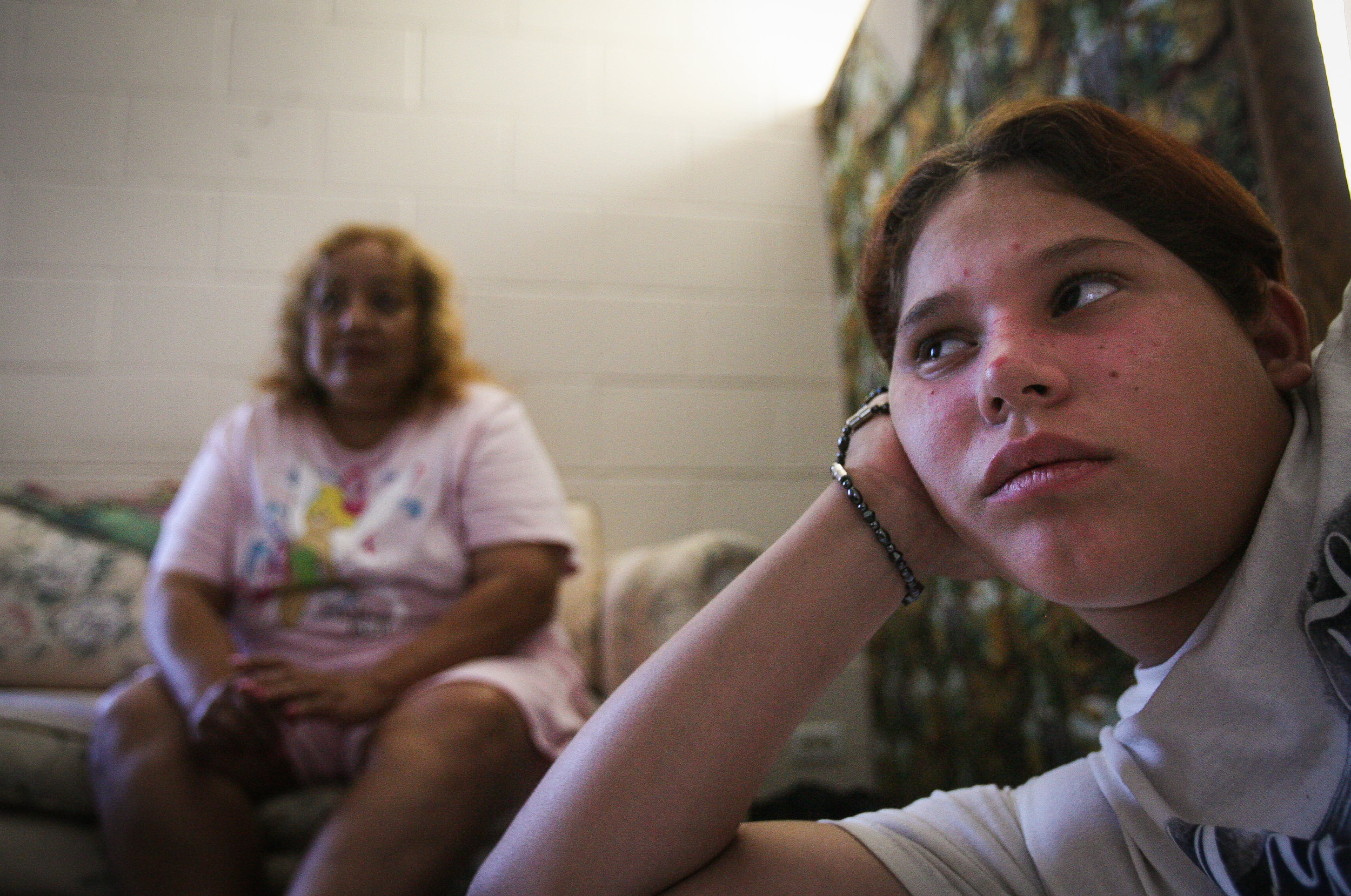  Angelica Brito, 12, right, and her mother, Juanita Torres, watch television at the Salvation Army Emergency Shelter before going to an evening church service Aug. 3, 2008, in Odessa, Texas. 