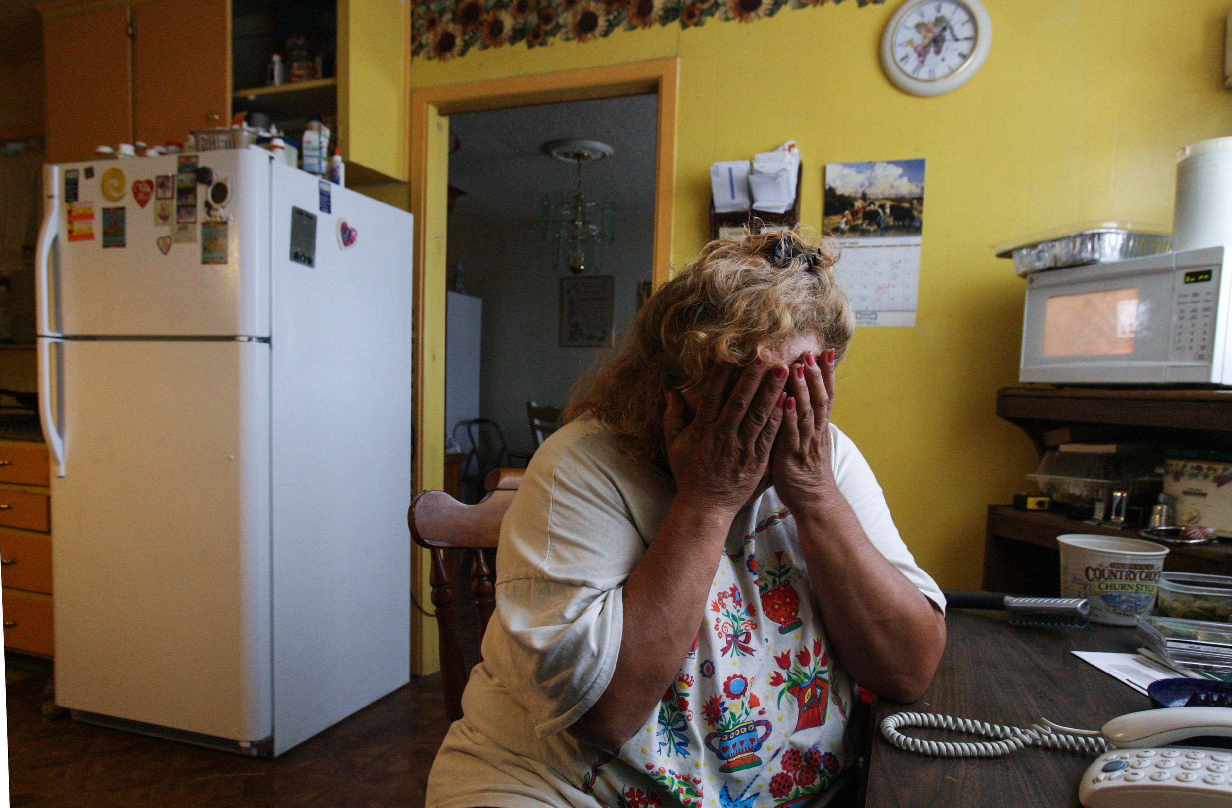  Juanita Torres reacts after learning during a phone call she was denied housing assistance Aug. 11, 2008, at her friend's house in Odessa, Texas. 