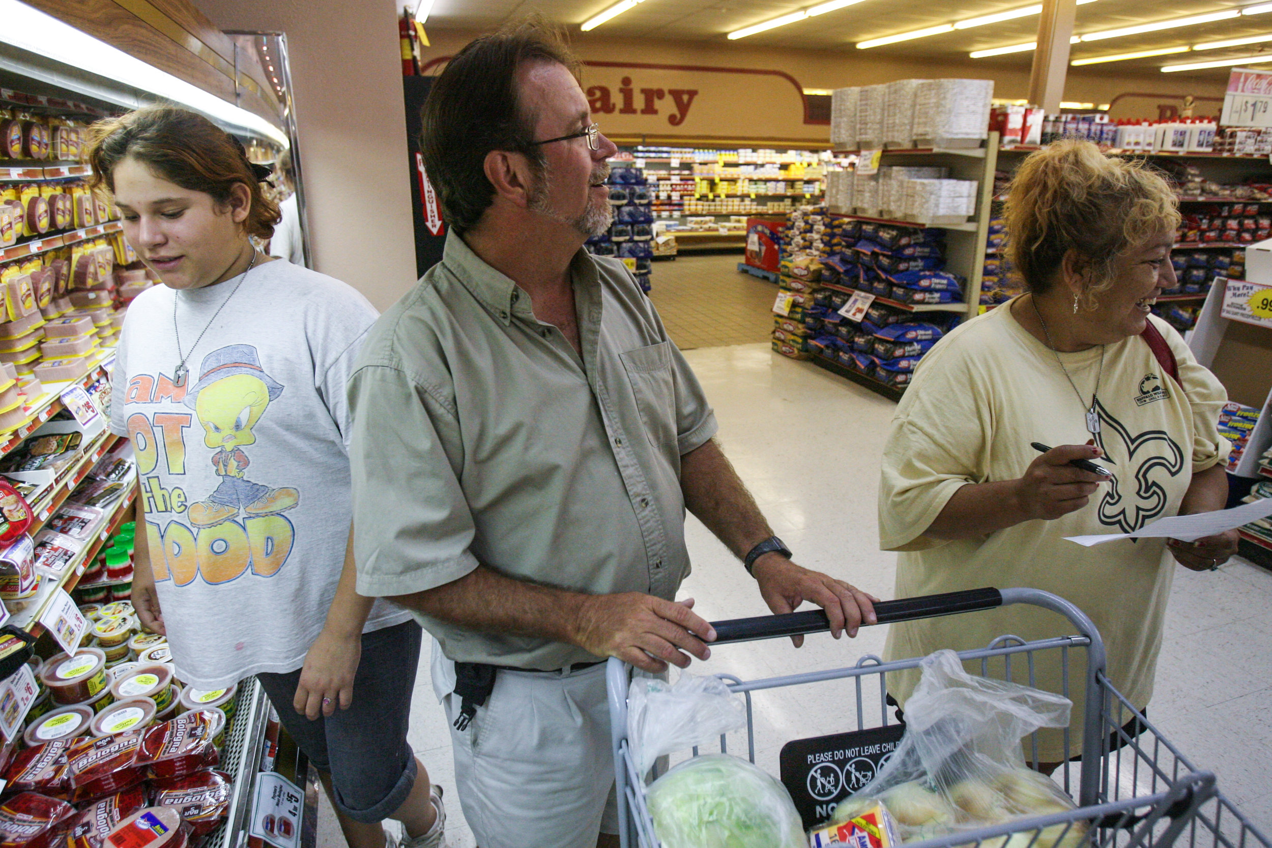  Angelica Brito, 12, from left, Steve Seward and Juanita Torres shop for groceries for Seward's mother Saturday, Aug. 23, 2008, at the Porter's grocer in Crane, Texas. 