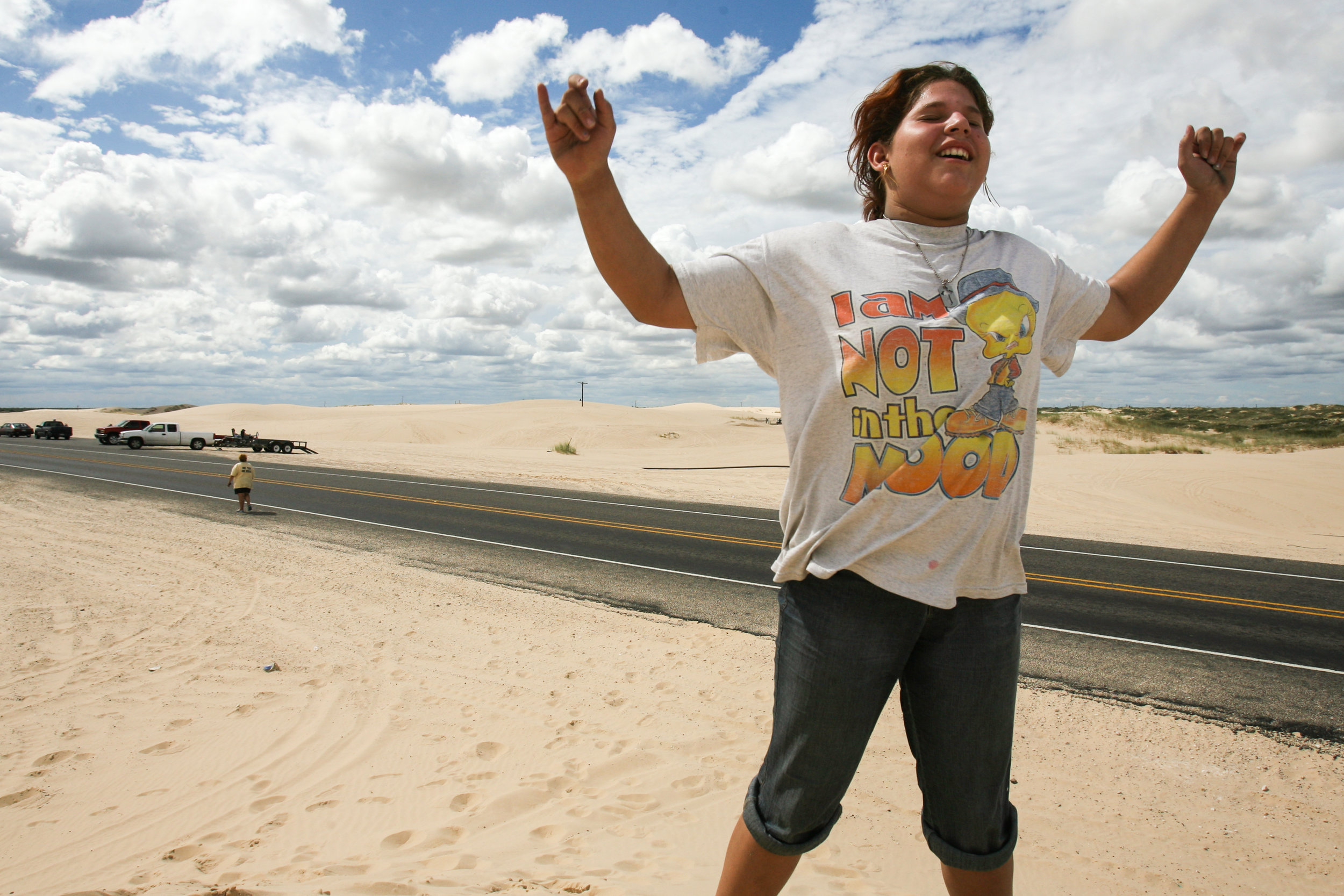  Angelica Brito, 12, celebrates successfully scaling a sand dune Saturday, Aug. 23, 2008, near the intersection of Farm to Market Roads 1053 and 1233 in Crane County, Texas. Brito and her mother took a trip out of Odessa for the day with fellow shelt