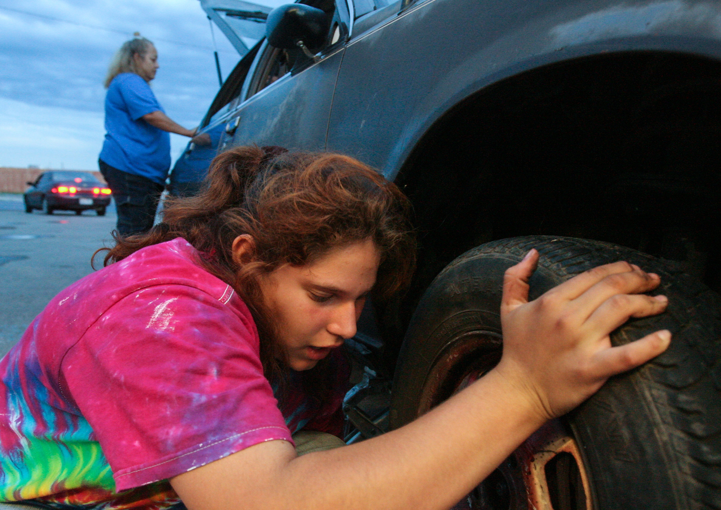  Angelica Brito, 12, removes a flat tire from her mother's car Tuesday, Sept. 2, 2008, at a 7-Eleven in east Odessa, Texas. On nights when they can't make it to the Salvation Army Emergency Shelter before it closes they have to sleep in the car. 