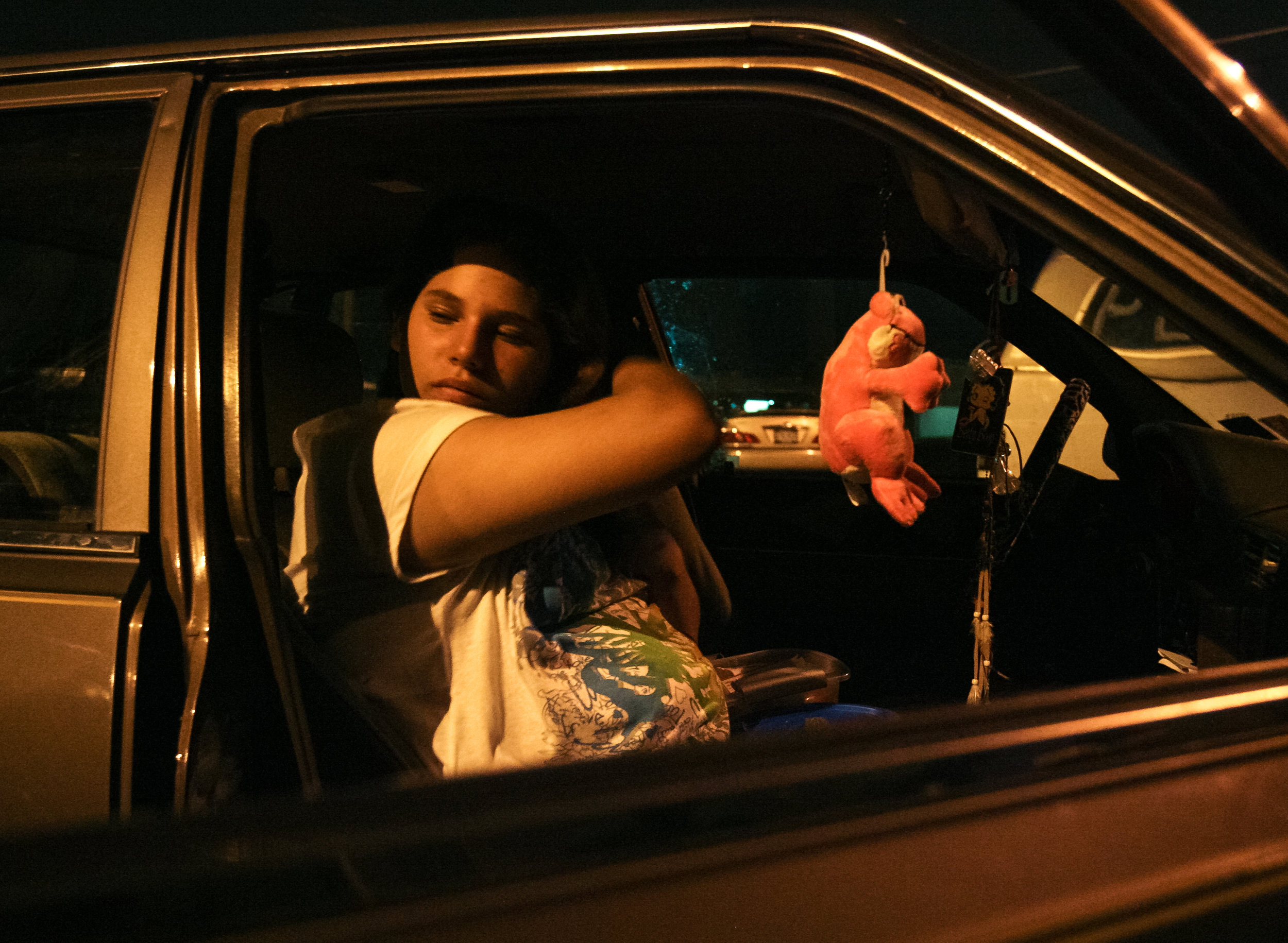  Angelica Brito, 12, brushes her hair by the light of a street lamp while waiting for some breakfast Sept. 3, 2008, at the 6th and Jackson Church of Christ in Odessa, Texas. The church offers breakfast for the homeless on certain mornings. 