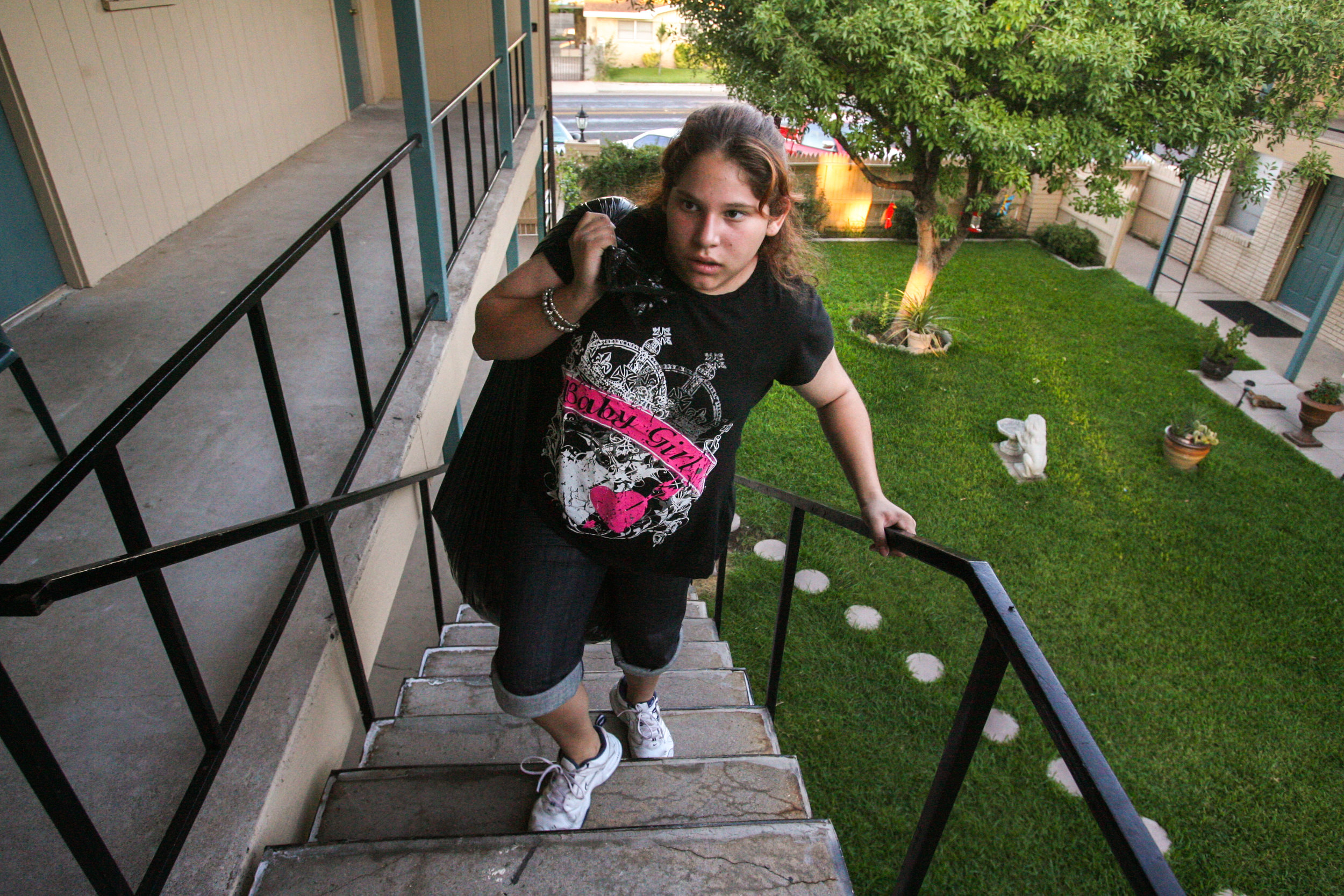  Angelica Brito , 12, climbs the stairs to the new apartment she'll share with her mom as she brings a sack full of belongings Saturday, Sept. 6, 2008, at the Maple Terrace Apartments in Odessa, Texas. 