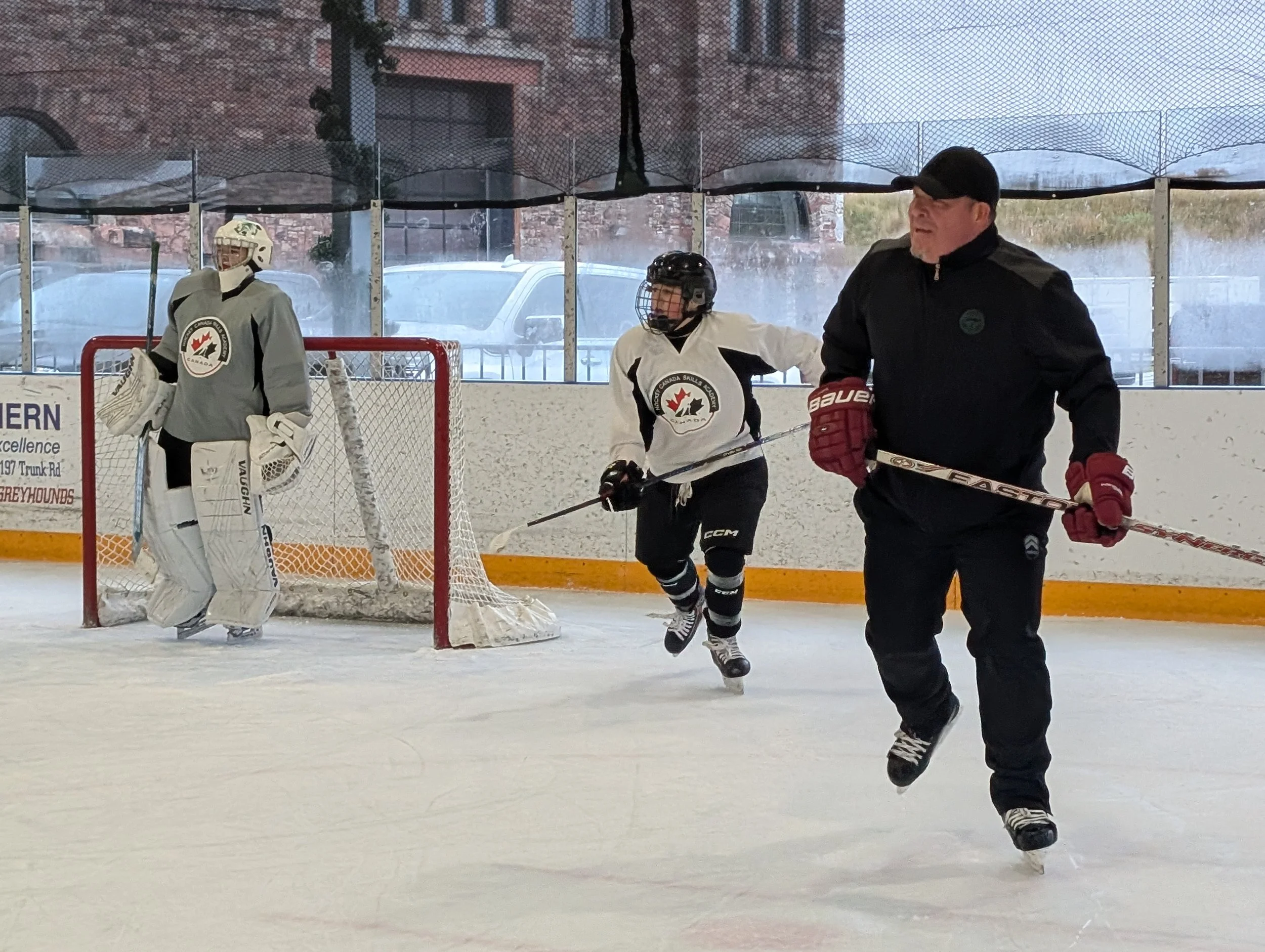 Denny on ice with HCSA students at net.jpg