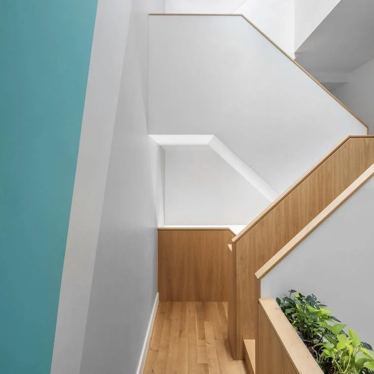 Light filtering down onto the stairs and bridge-like hallways in our Williamsburg townhouse.