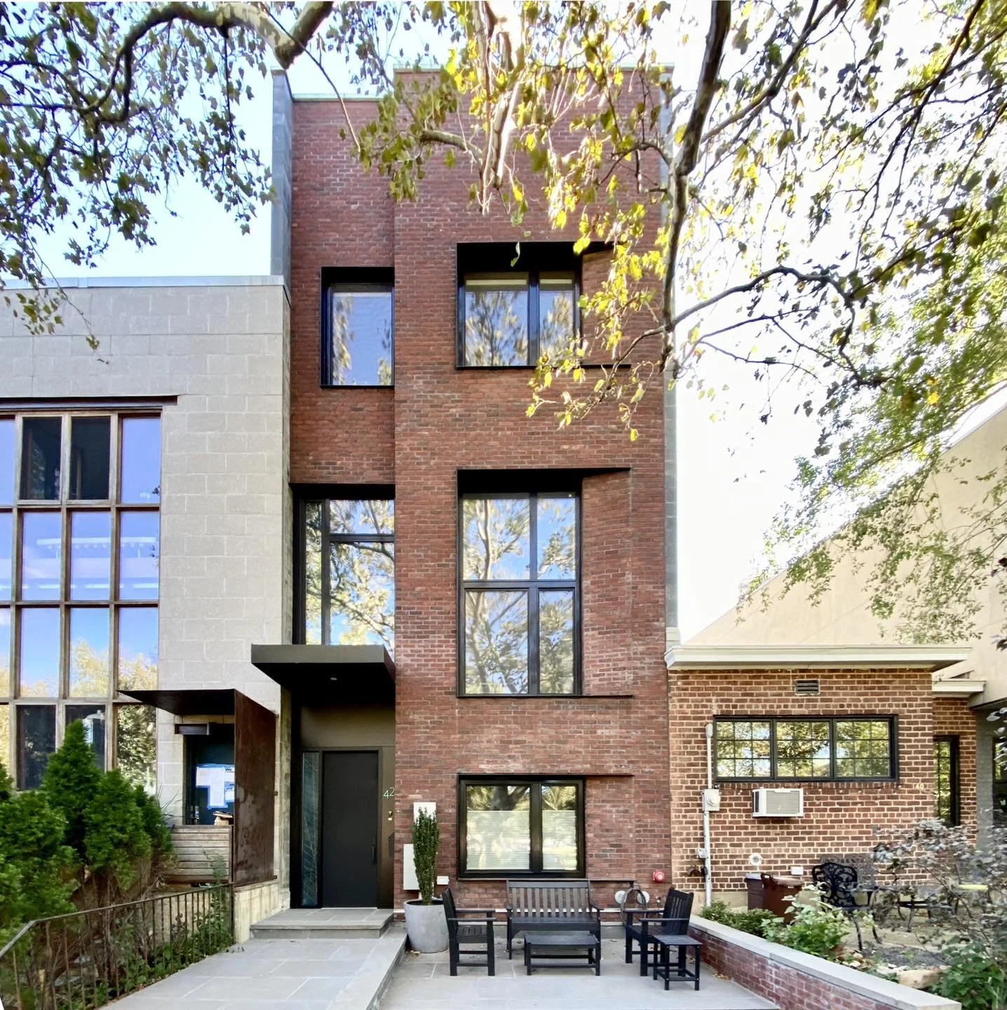 The subdued facade of our Williamsburg Townhouse, featuring brick, steel and concrete block, emulates the surrounding context of brick warehouse buildings that exist in this corner of the neighborhood.