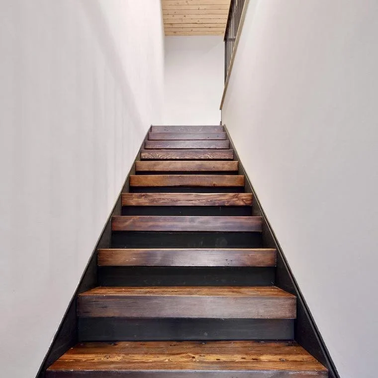 Repurposing demo material:  here are stair treads and ceiling slats made out of studs that were removed while reconfiguring this 1860s building. The stair treads were built up like butcher block out of the old wood material and set into steel stringe