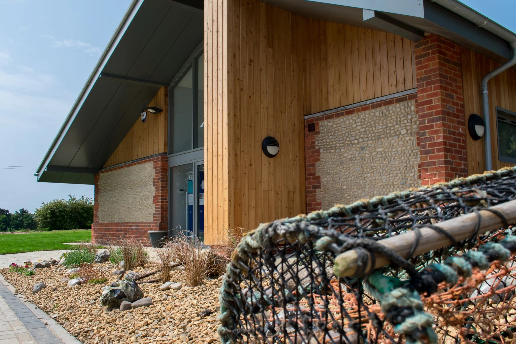 The Building has been influenced by the north norfolk coast, using materials which  compliment its surroundings. The form creates sharp angles and shadows, creating a sense of interest upon the main facade.