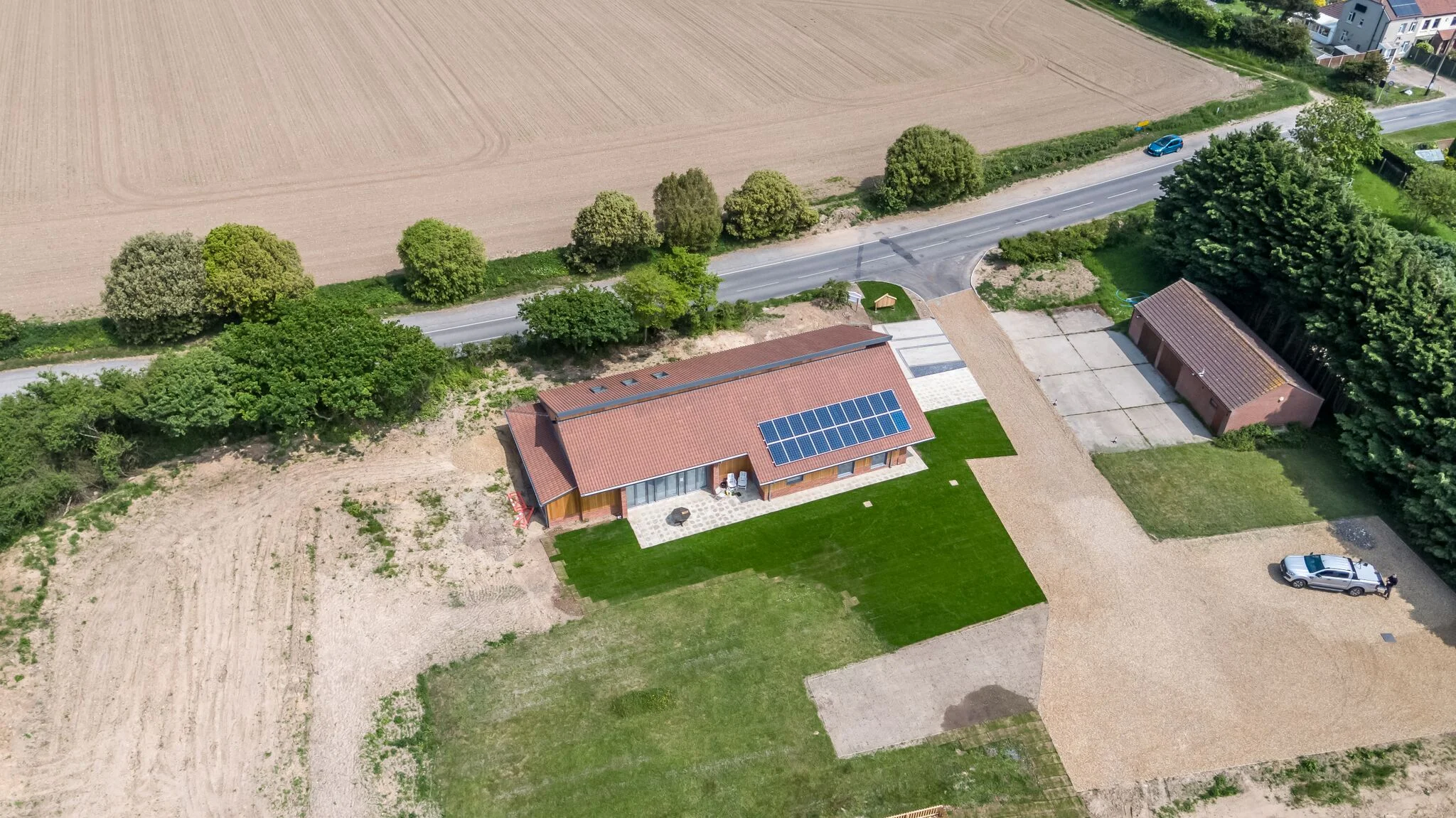 Image showing the new hall from above. The grass will continue to grow over the next few years, allowing this space to be used by all ages. The building is powered by solar panels, together with ground source heating. Please click on the below video