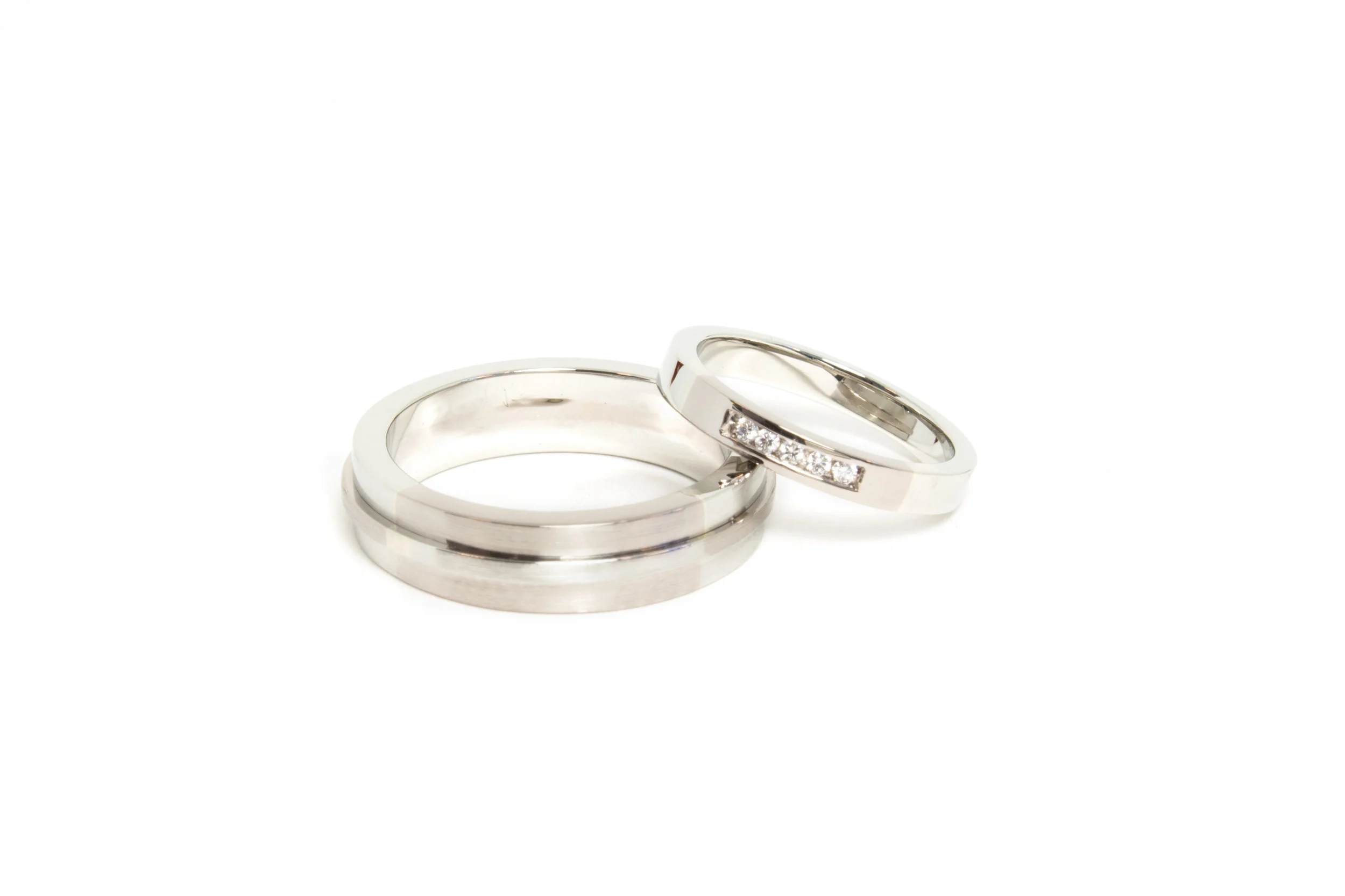 Wedding Bands in 18kt Palladium White Gold and 18kt Gold, with channel set diamonds.