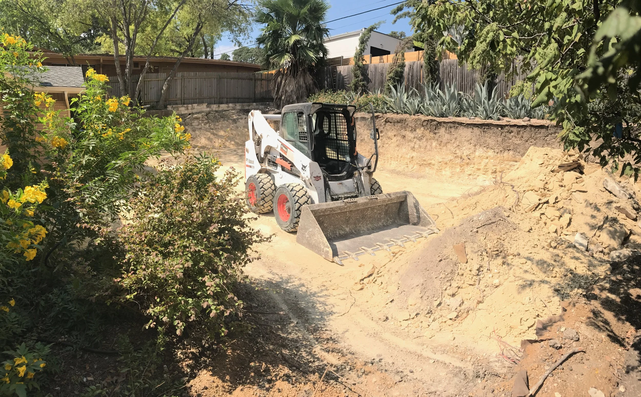 This excavation picture highlights one of Trade Ready Deconstruction's skid steers completing another service offered to our clients. 
