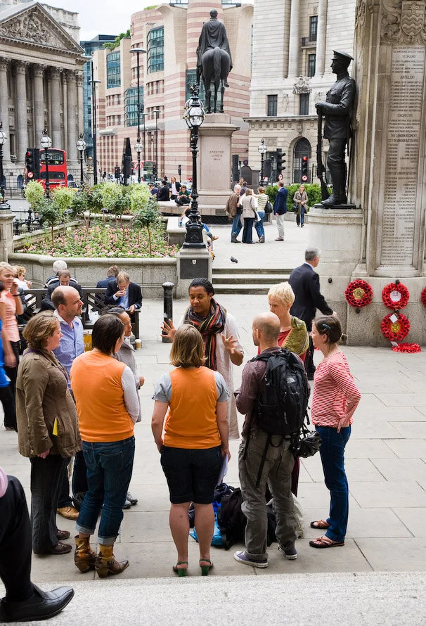 A circle of people listen to a speaker outside the Bank of England