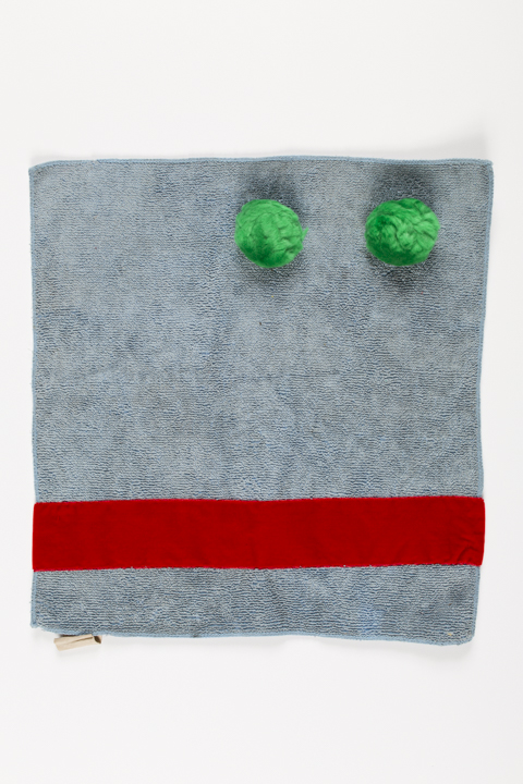 Used grey dishcloth with the suggestion of a face in red and green