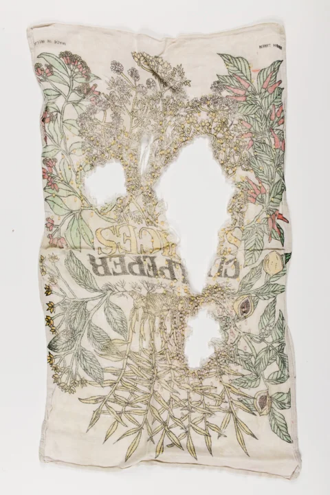 Tea towel with floral motif and three holes