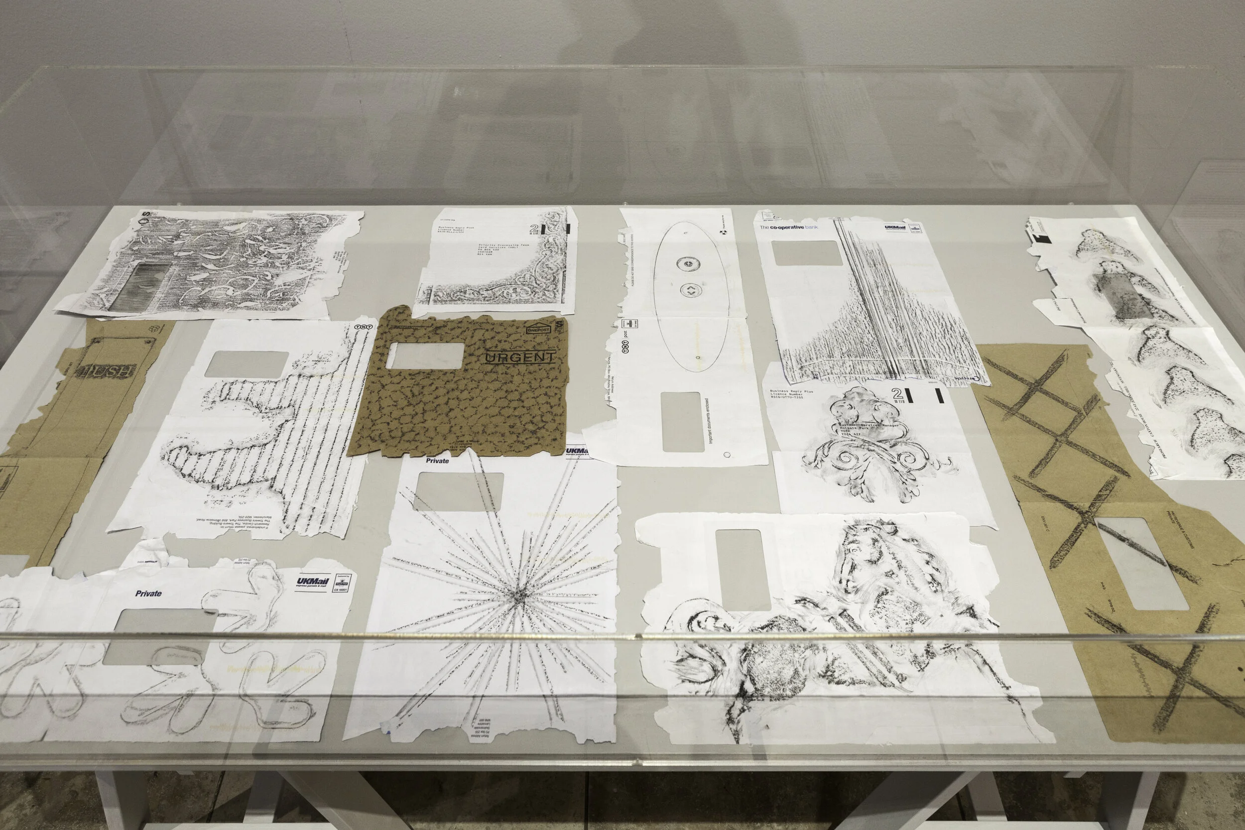 Display case with 13 envelopes covering with a variety of rubbings