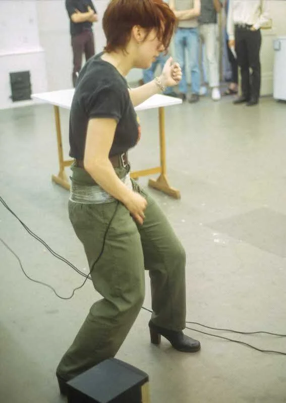 Hayley Newman playing air guitar 
