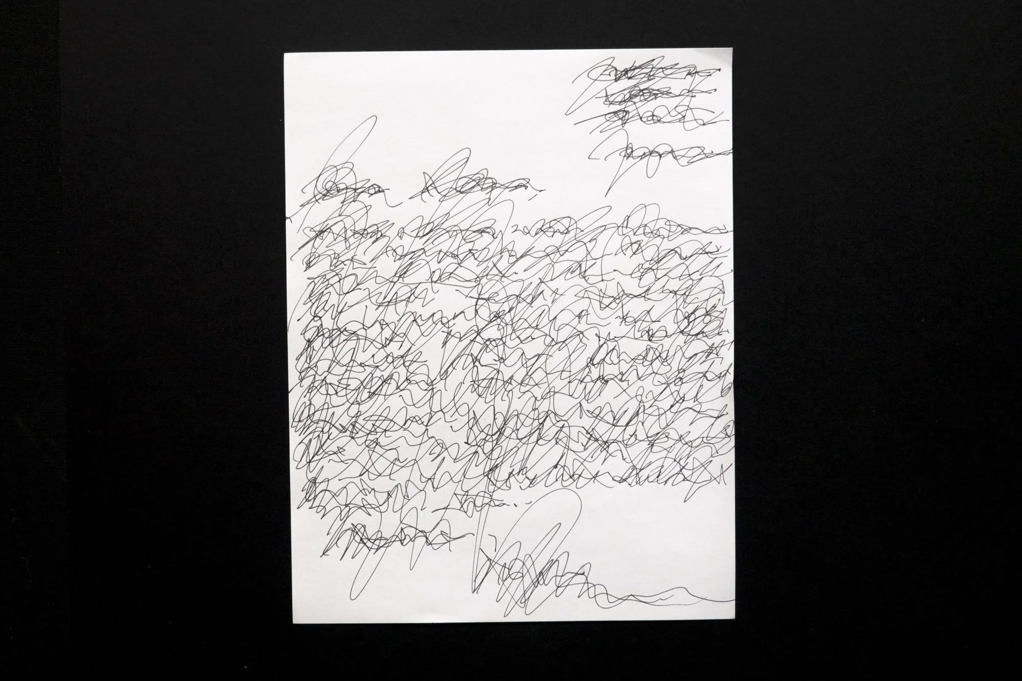 Black ink on paper that appears to be a handwritten letter overwritten several times and is completely illegible