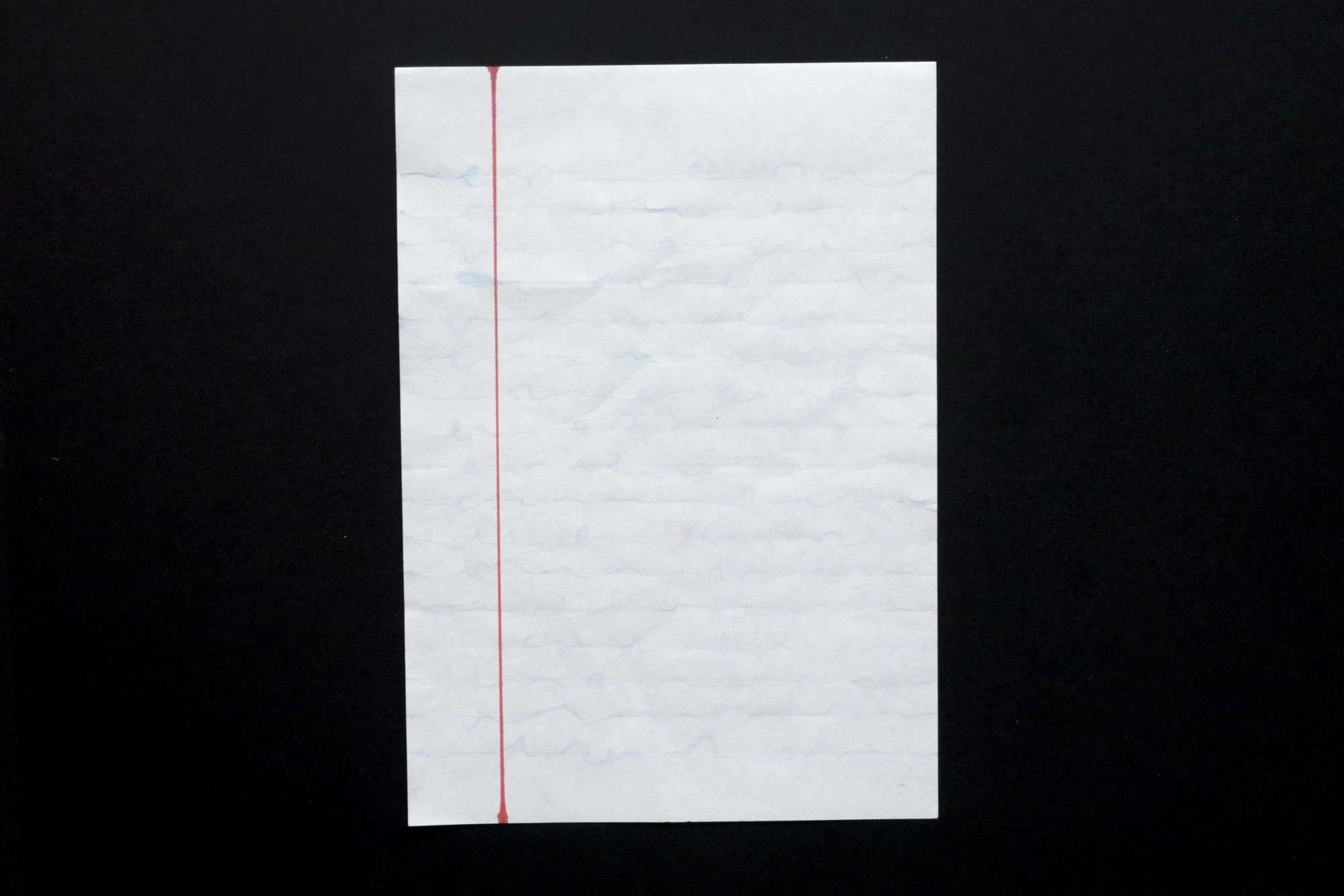 A white piece of paper on which irregular very faint lines appear like illegible handwriting