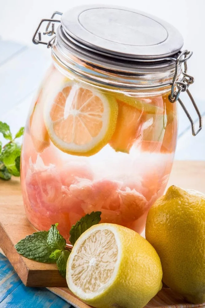 jar-of-organic-lemons-and-grapefruit-on-wooden-plank-on-table.jpg