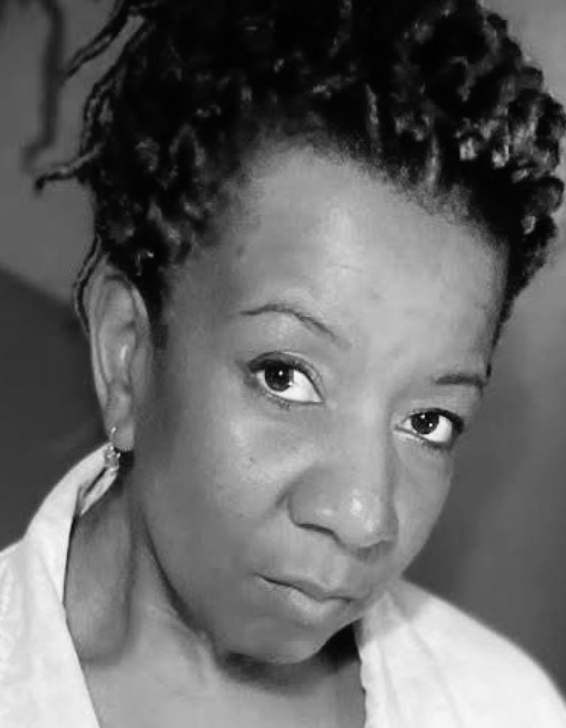 B&W photo of Dionne Draper looking straight at the camera