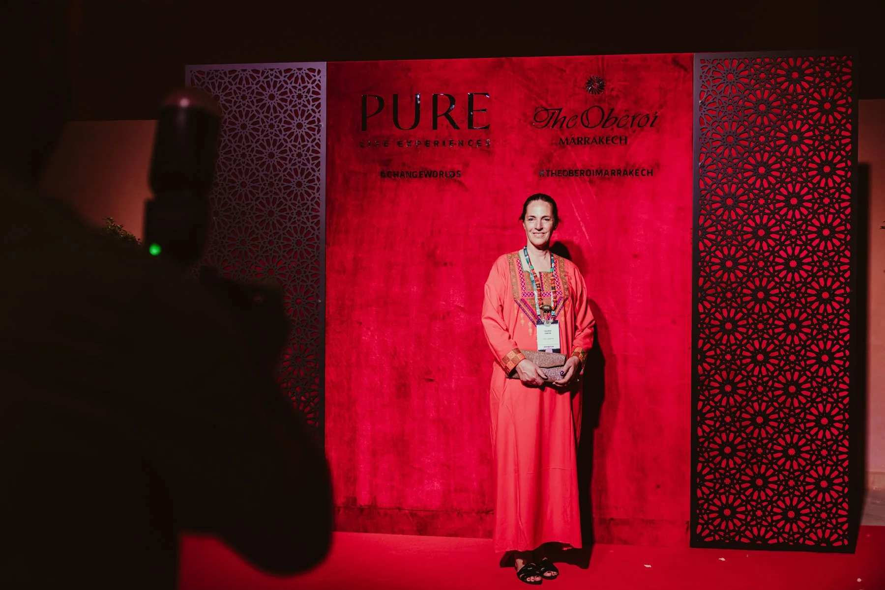 Guest posing at step and repeat backdrop
