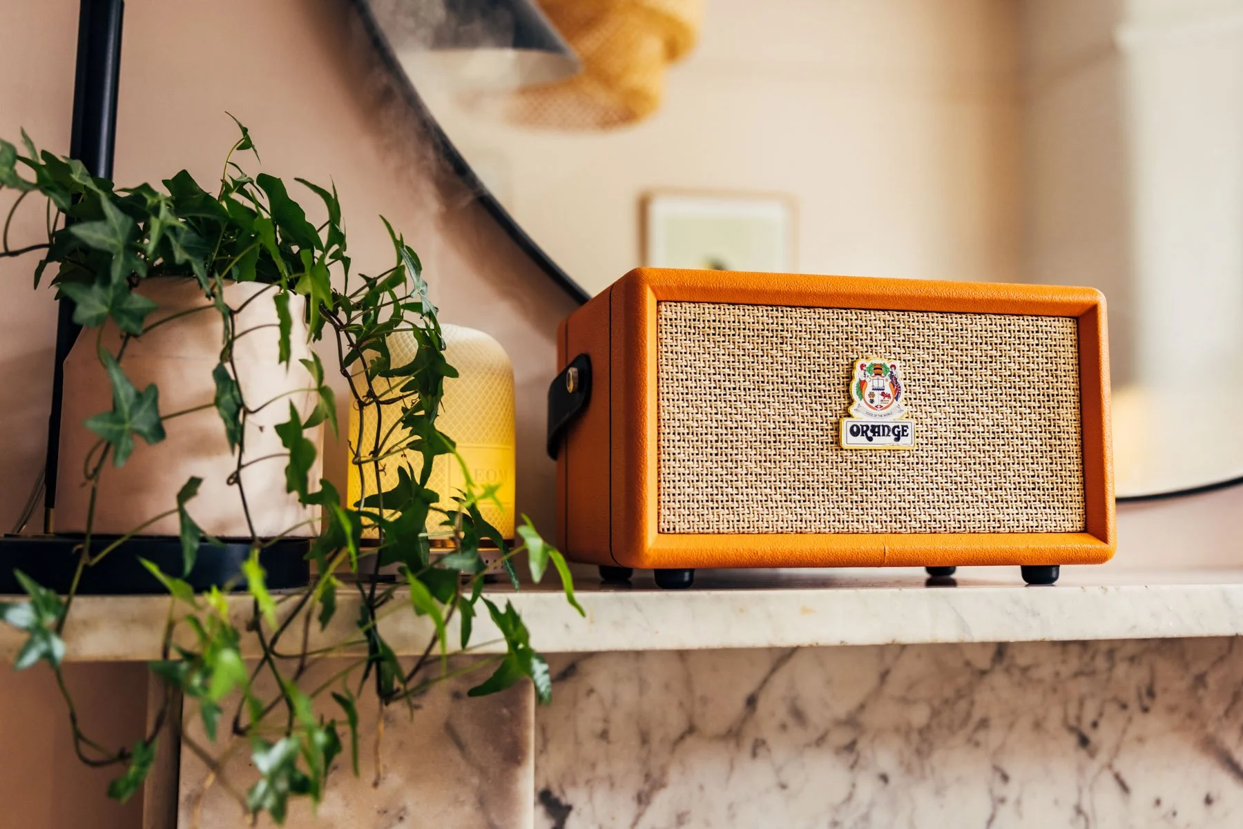 Advertising photography of orange speakers in styled setting