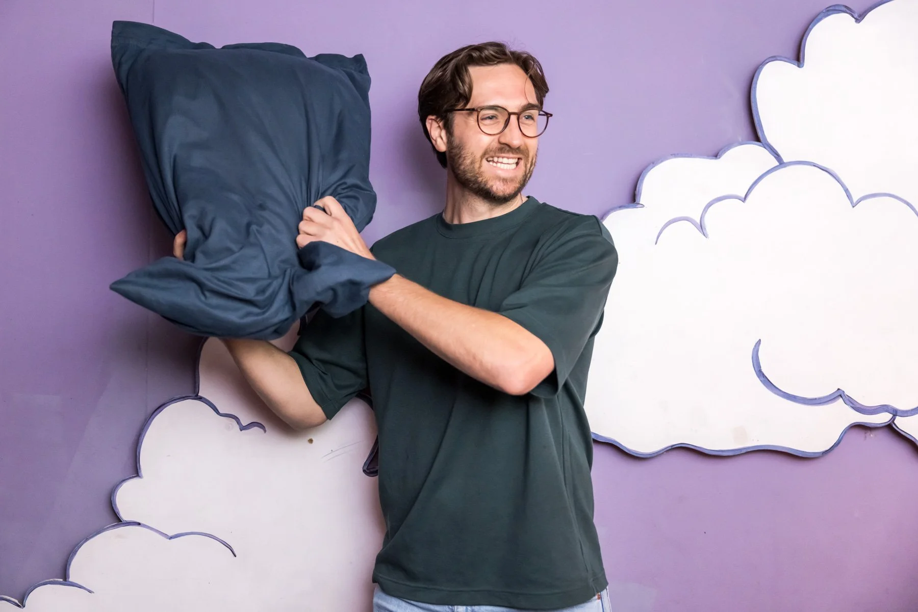 Experiential brand photography of man in pillow fight