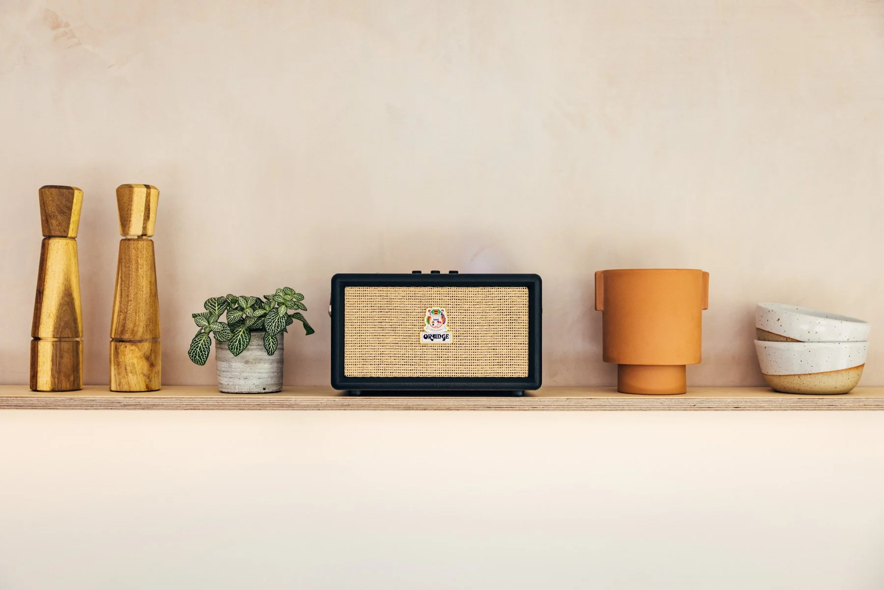 Advertising photography of orange speakers in styled setting