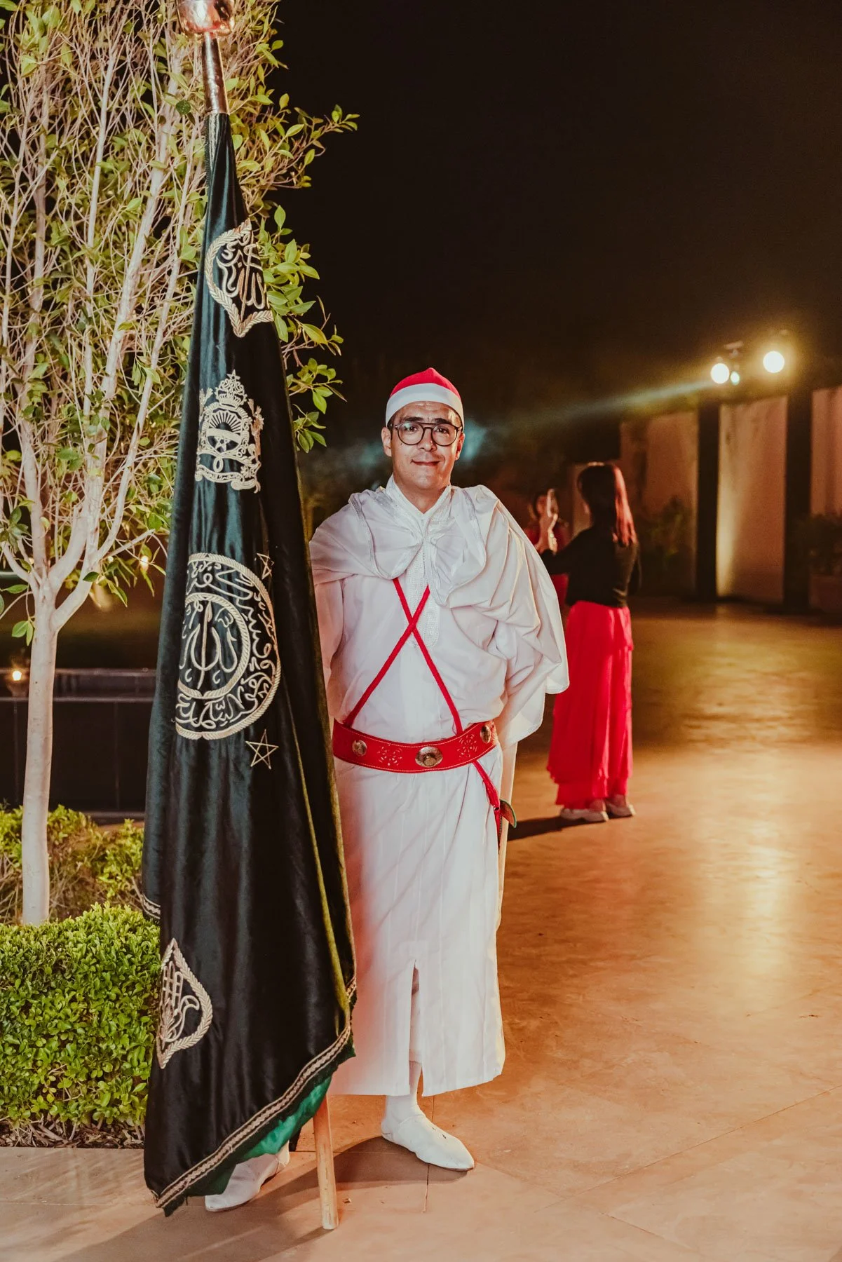 Man in traditional Moroccan attire greeting guests on arrival